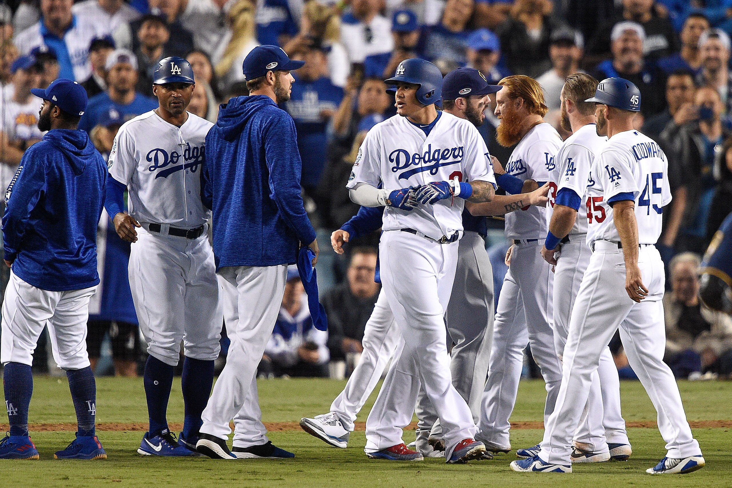 LOS ANGELES, CA - OCTOBER 16:  Manny Machado #8 of the Los Angeles Dodgers is separated from a scuffle with Jesus Aguilar #24 of the Milwaukee Brewers (not pictured) during the tenth inning in Game Four of the National League Championship Series at Dodger