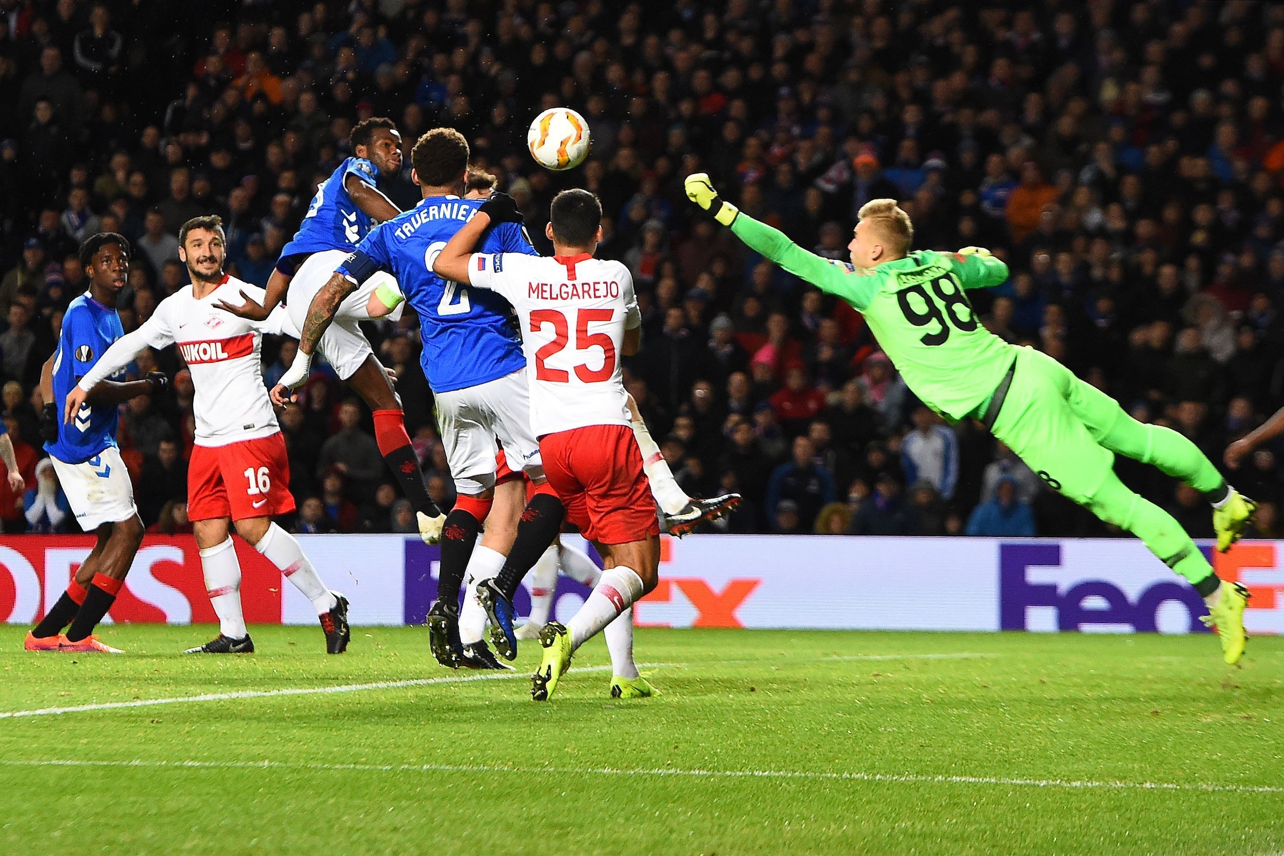 Spartak Moscow's Russian goalkeeper Aleksandr Maksimenko (R) dives to bunch the ball clear during the UEFA Europa League Group G football match between Rangers and Spartak Moscow at Ibrox Stadium in Glasgow on October 25, 2018. (Photo by ANDY BUCHANAN / A