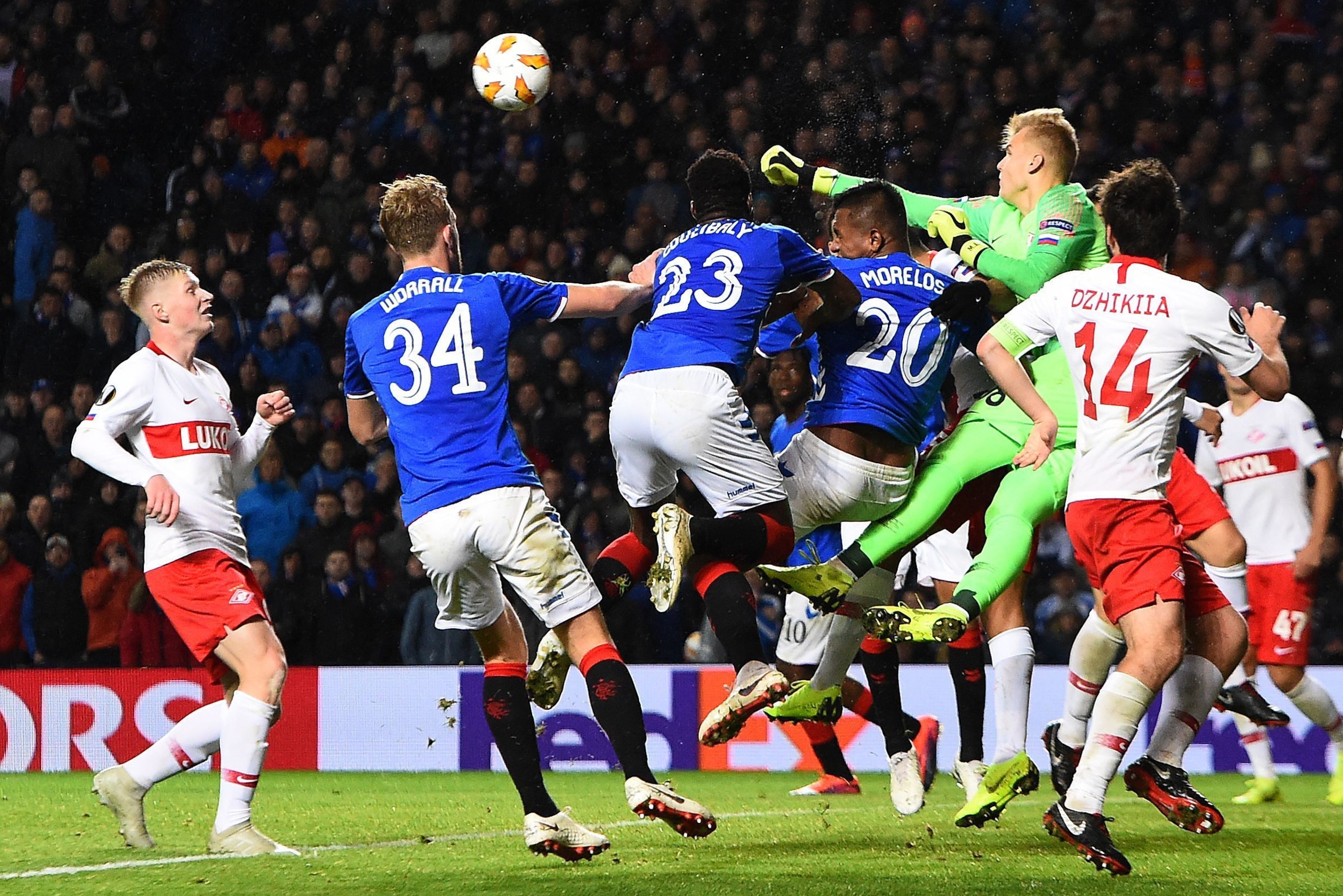Spartak Moscow's Russian goalkeeper Aleksandr Maksimenko (2R) punches the ball clear of Rangers' Colombian forward Alfredo Morelos (3R) during the UEFA Europa League Group G football match between Rangers and Spartak Moscow at Ibrox Stadium in Glasgow on 
