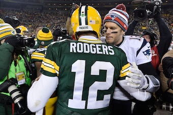 GREEN BAY, WI - NOVEMBER 30:  Tom Brady #12 of the New England Patriots (R) congratulates fellow quarterback Aaron Rodgers #12 of the Green Bay Packers after their game at Lambeau Field on November 30, 2014 in Green Bay, Wisconsin.  The Packers defeated t