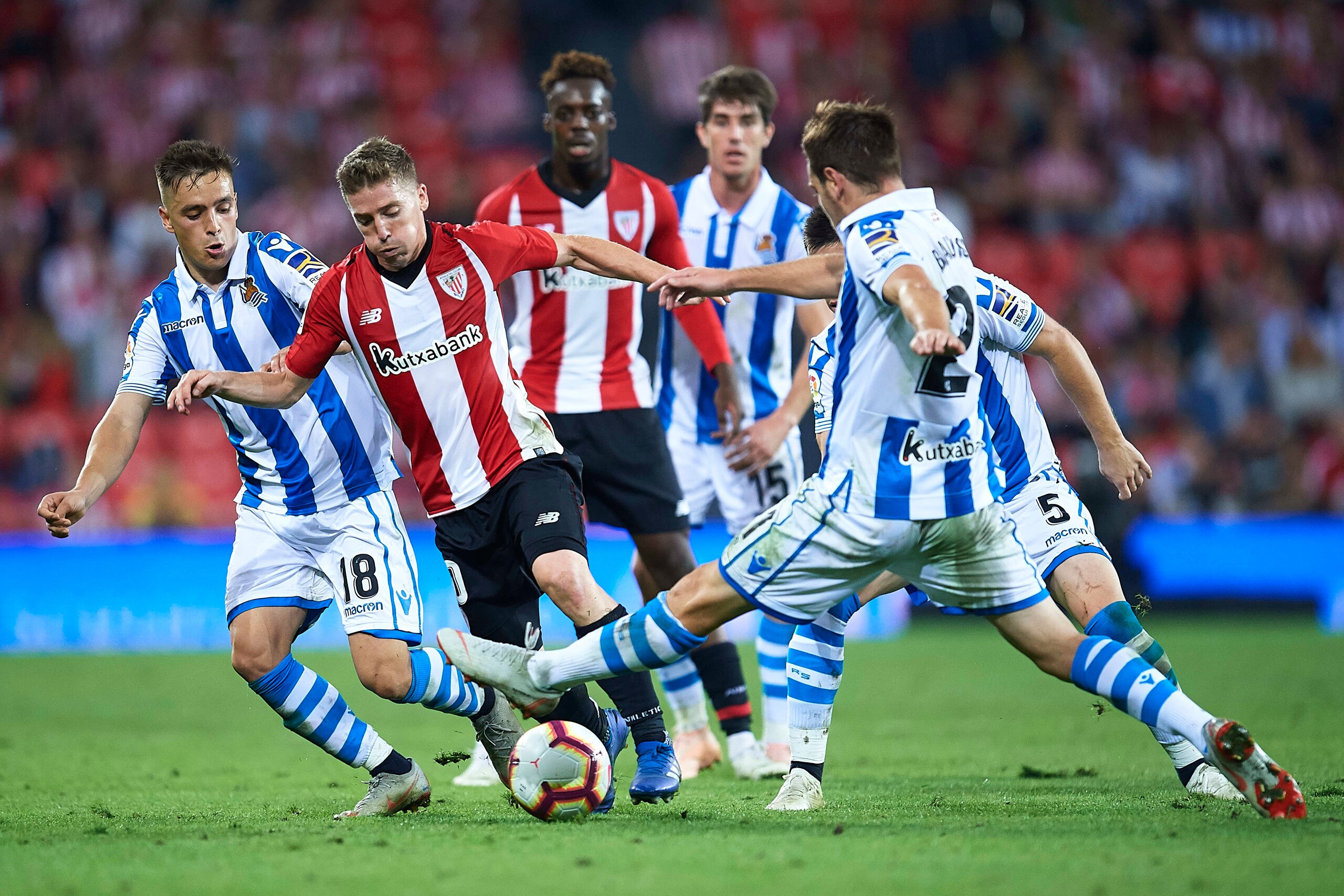 BILBAO, SPAIN - OCTOBER 05:  Iker Muniain of Athletic Club (C) being followed by Andoni Gorosabel of Real Sociedad  ((L) and Joseba Zaldua of Real Sociedad (R) during the La Liga match between Athletic Club and Real Sociedad at San Mames Stadium on Octobe
