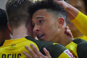 Dortmund's English midfielder Jadon Sancho (R) celebrates scoring the opening goal with Dortmund's German forward Marco Reus during the German first division Bundesliga football match BVB Borussia Dortmund v Hertha Berlin in Dortmund, western Germany, on 