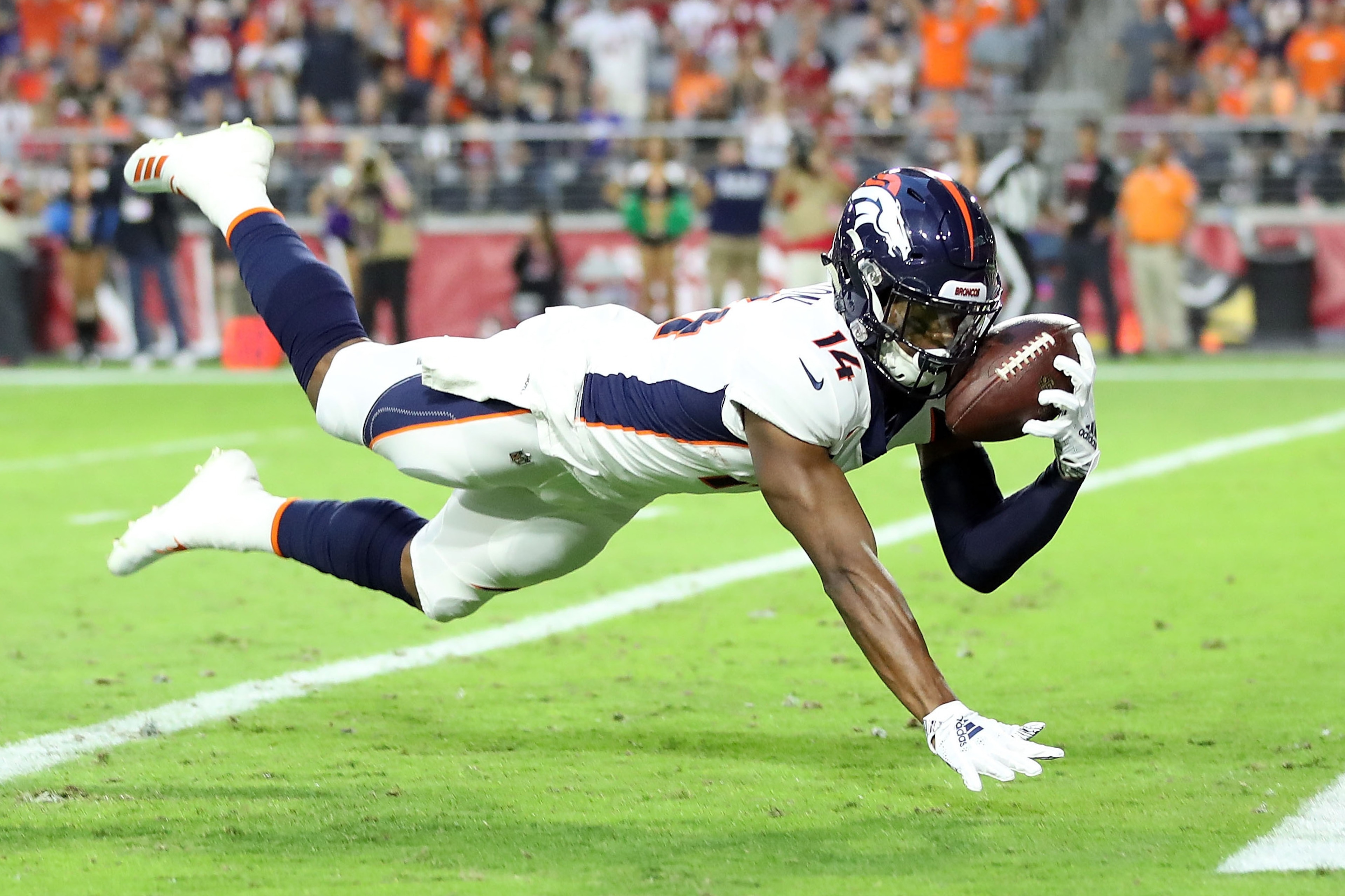 GLENDALE, AZ - OCTOBER 18: Wide receiver Courtland Sutton #14 of the Denver Broncos scores a 28-yard touchdown during the first quarter against the Arizona Cardinals at State Farm Stadium on October 18, 2018 in Glendale, Arizona. (Photo by Christian Pet GLENDALE, AZ - OCTOBER 18: Wide receiver Courtland Sutton #14 of the Denver Broncos scores a 28-yard touchdown during the first quarter against the Arizona Cardinals at State Farm Stadium on October 18, 2018 in Glendale, Arizona. (Photo by Christian Pet