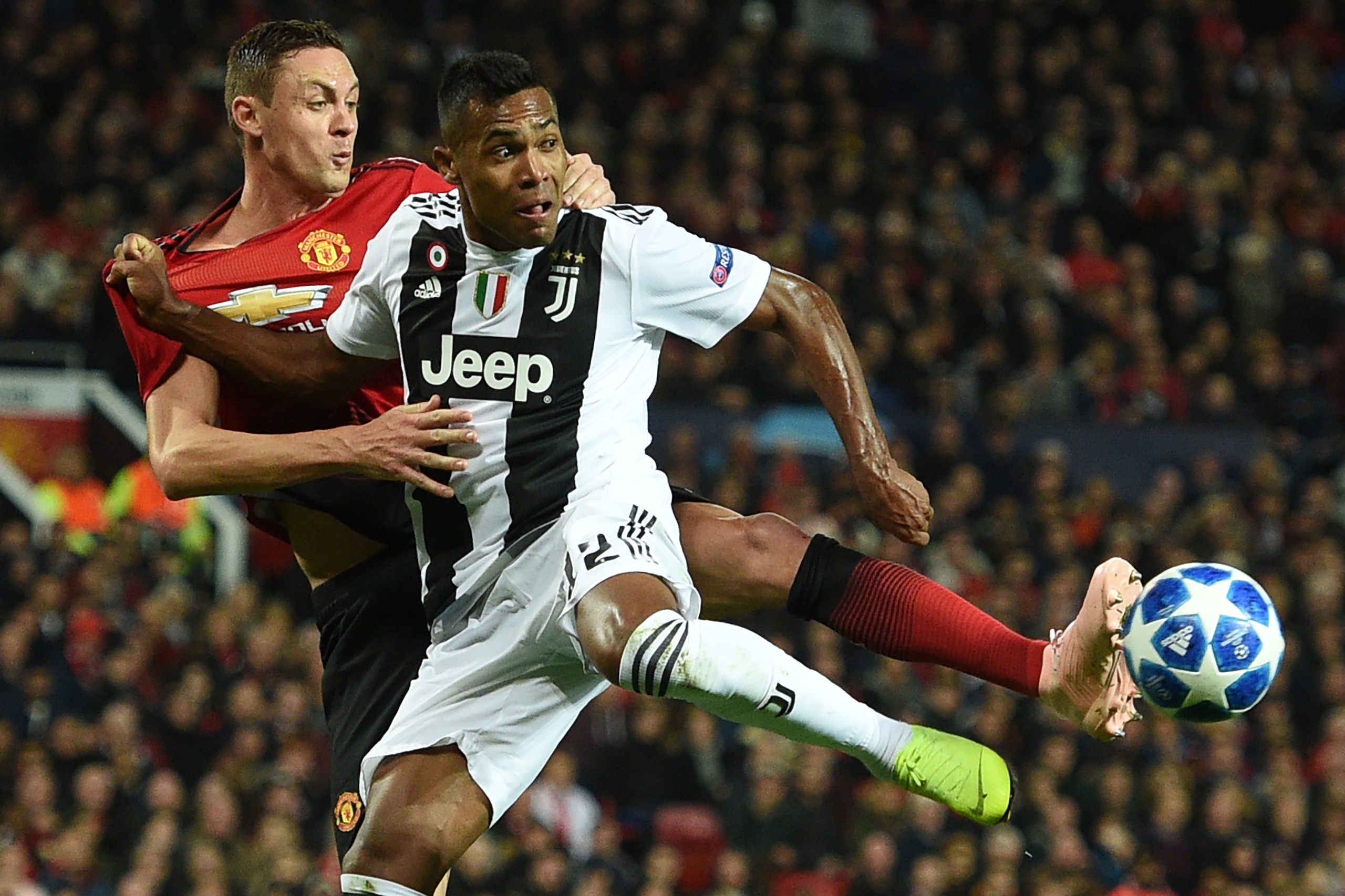Juventus' Brazilian defender Alex Sandro (R) vies with Manchester United's Serbian midfielder Nemanja Matic (L) during the Champions League group H football match between Manchester United and Juventus at Old Trafford in Manchester, north west England, on