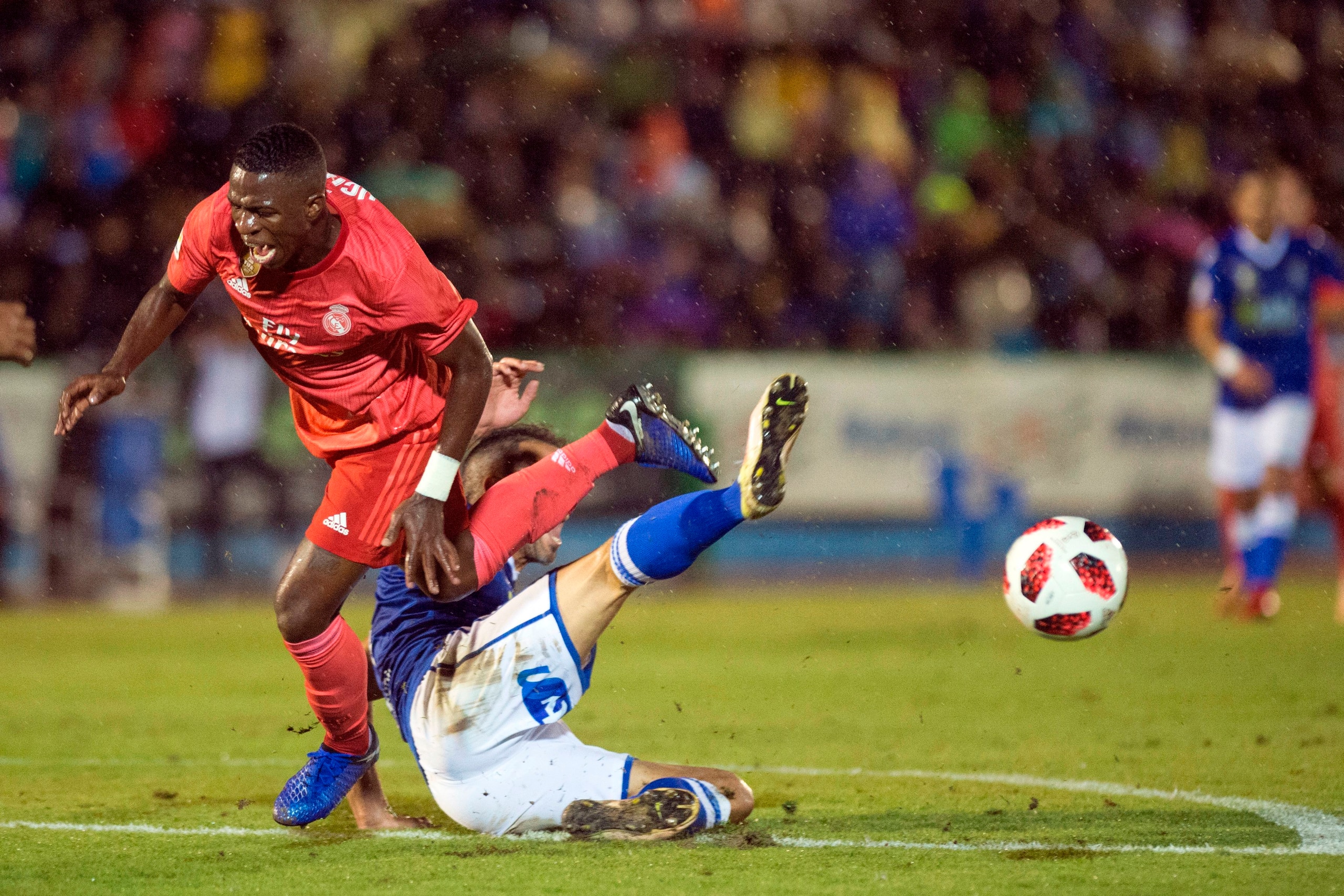 Real Madrid's Brazilian forward Vinicius Junior (L) vies with UD Melilla's Spanish defender Ricardo Segura Richi during the Spanish King's Cup (Copa del Rey) football match between UD Melilla and Real Madrid CF at the Alvarez Claro municipal stadium in th