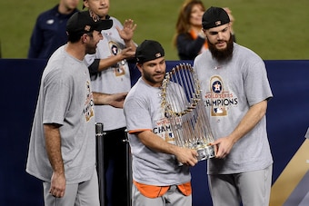 LOS ANGELES, CA - NOVEMBER 01:  (L-R) Justin Verlander #35, Jose Altuve #27, and Dallas Keuchel #60 of the Houston Astros hold the Commissioner's Trophy after defeating the Los Angeles Dodgers 5-1 in game seven to win the 2017 World Series at Dodger Stadi