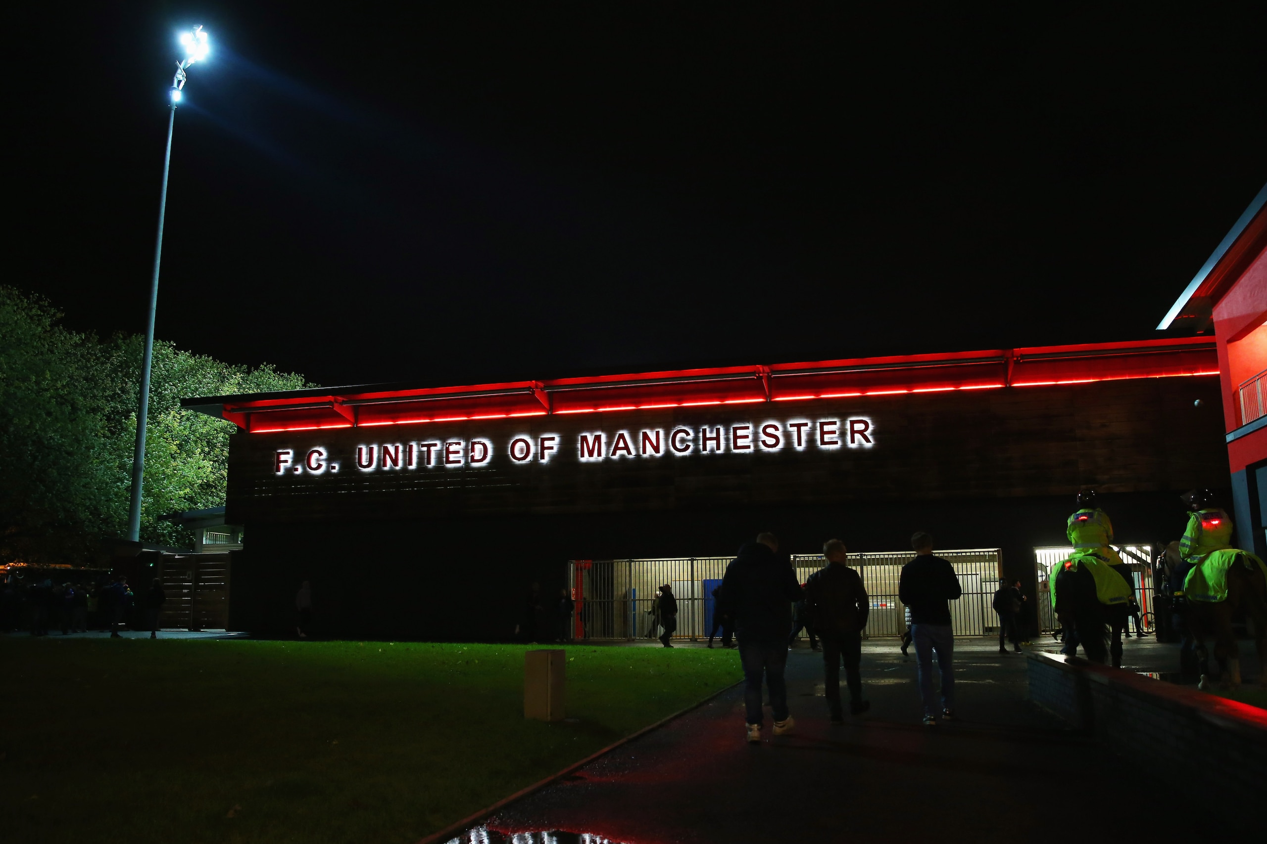 MANCHESTER, ENGLAND - NOVEMBER 09:  Fans walk outside the stadium prior to the Emirates FA Cup first round match between FC United of Manchester and Chesterfield at Broadhurst Park on November 9, 2015 in Manchester, England.  (Photo by Alex Livesey/Getty 