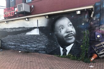 A mural of Martin Luther King, Jr. adorns the side of a market in a neighborhood of Southeast Washington, D.C.