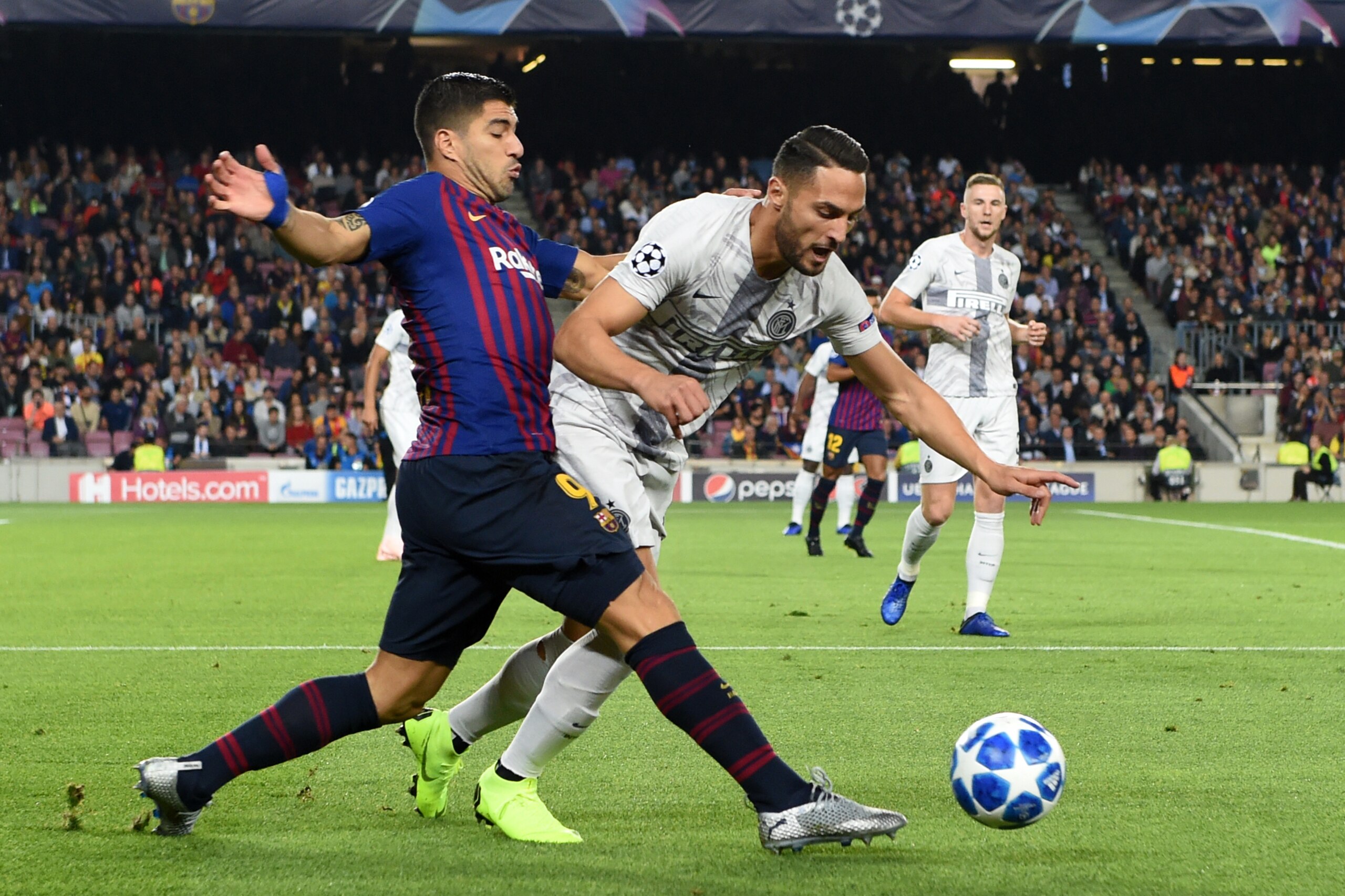 BARCELONA,SPAIN - OCTOBER 24: Luis Suarez (L) of Barcelona and Danilo D'Ambrosio of Inter compete for the ball during the Group B match of the UEFA Champions League between FC Barcelona and FC Internazionale at Camp Nou on October 24, 2018 in Barcelona, S