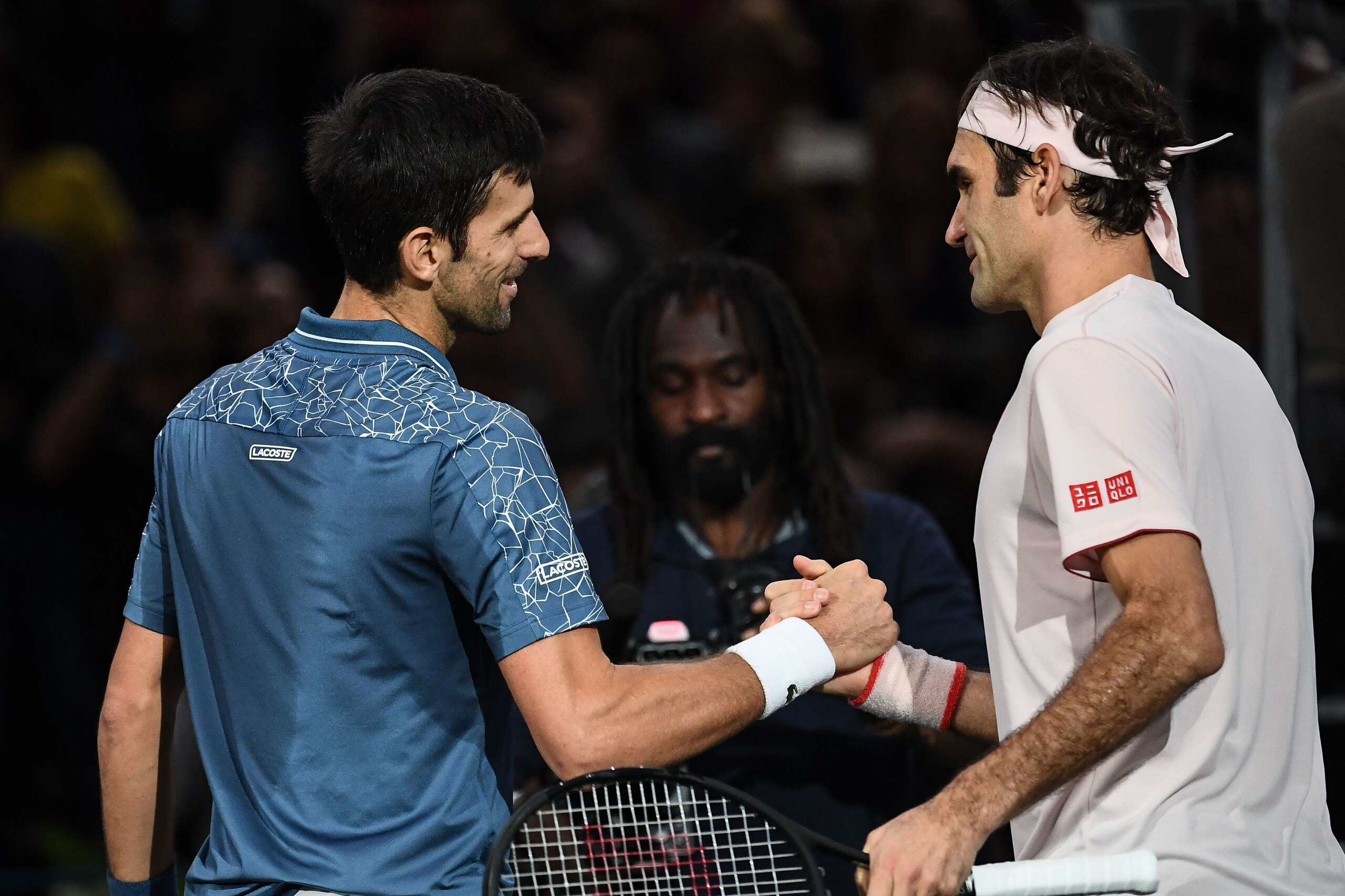 Serbia's Novak Djokovic (L) and Switzerland's Roger Federer shake hands at the end of their men's singles semi-final tennis match on day six of the ATP World Tour Masters 1000 - Rolex Paris Masters - indoor tennis tournament at The AccorHotels Arena in Pa