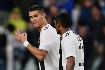 Juventus' midfielder Douglas Costa (R) from Brazil celebrates with teammate Juventus' Portuguese forward Cristiano Ronaldo (L) after scoring a goal during the Italian Serie A football match Juventus vs Cagliari on November 3, 2018 at the 'Allianz Stadium'
