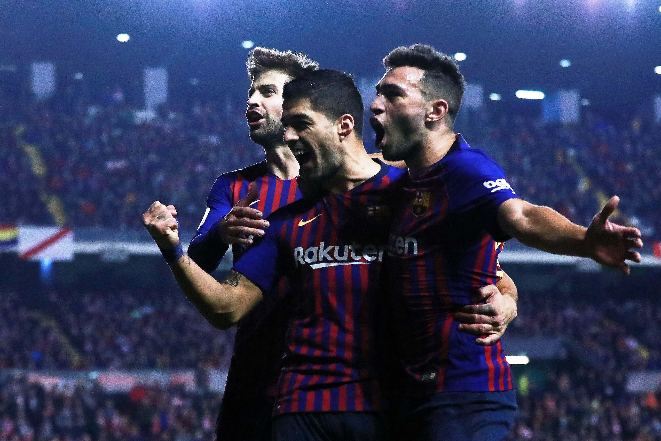 MADRID, SPAIN - NOVEMBER 03:  Luis Suarez (2ndL) of FC Barcelona celebrates scoring their third goal with teammates Gerard Pique (L) and Munir El Haddadi (R) during the La Liga match between Rayo Vallecano de Madrid and FC Barcelona at Campo de Futbol de 