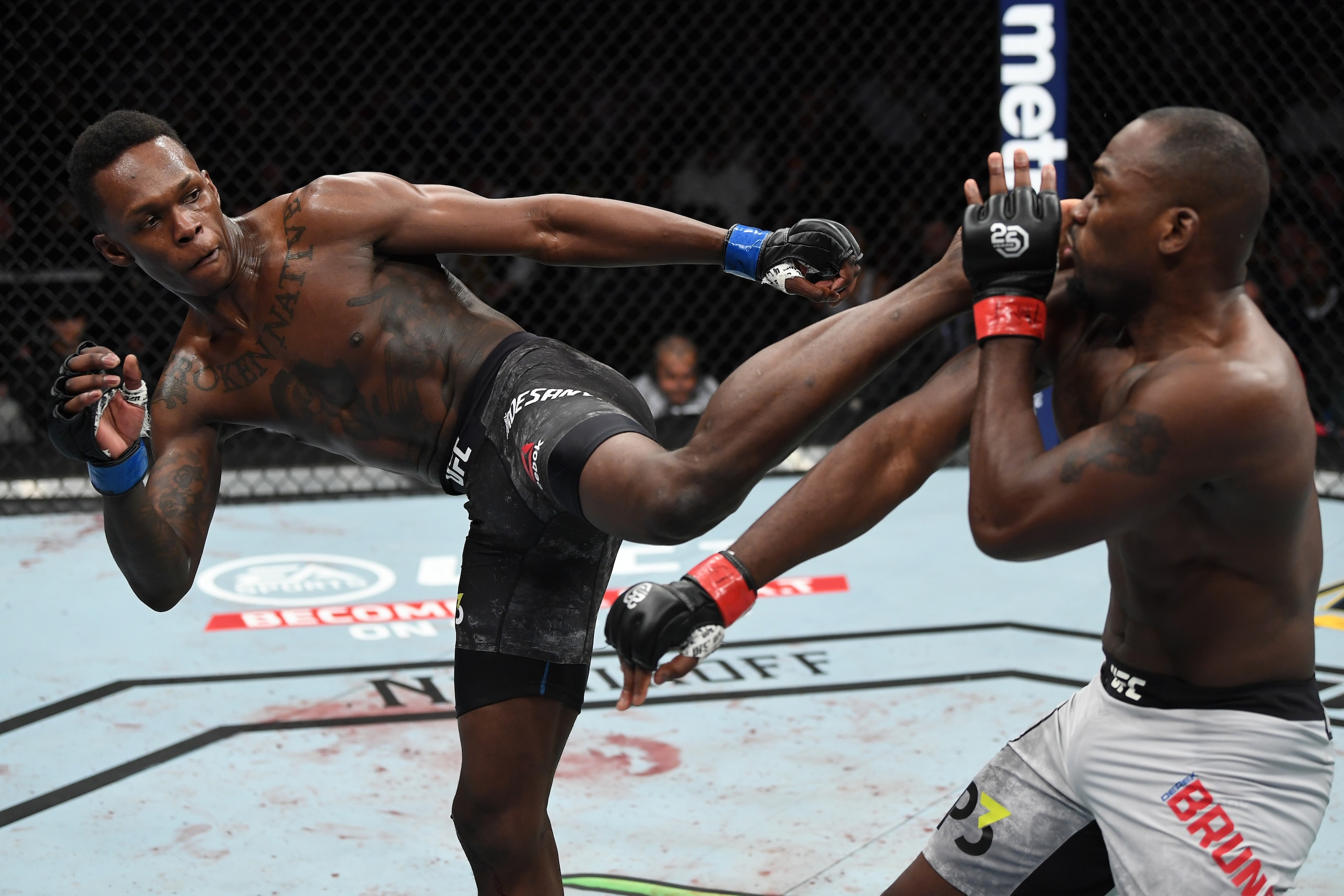 NEW YORK, NY - NOVEMBER 03:  (L-R) Israel Adesanya of Nigeria kicks Derek Brunson in their middleweight bout during the UFC 230 event inside Madison Square Garden on November 3, 2018 in New York, New York. (Photo by Jeff Bottari/Zuffa LLC/Zuffa LLC via Ge
