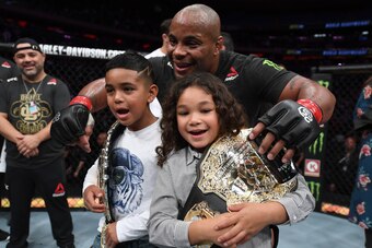 NEW YORK, NY - NOVEMBER 03:  Daniel Cormier celebrates with his kids after his submission victory over Derrick Lewis in their UFC heavyweight championship bout during the UFC 230 event inside Madison Square Garden on November 3, 2018 in New York, New York