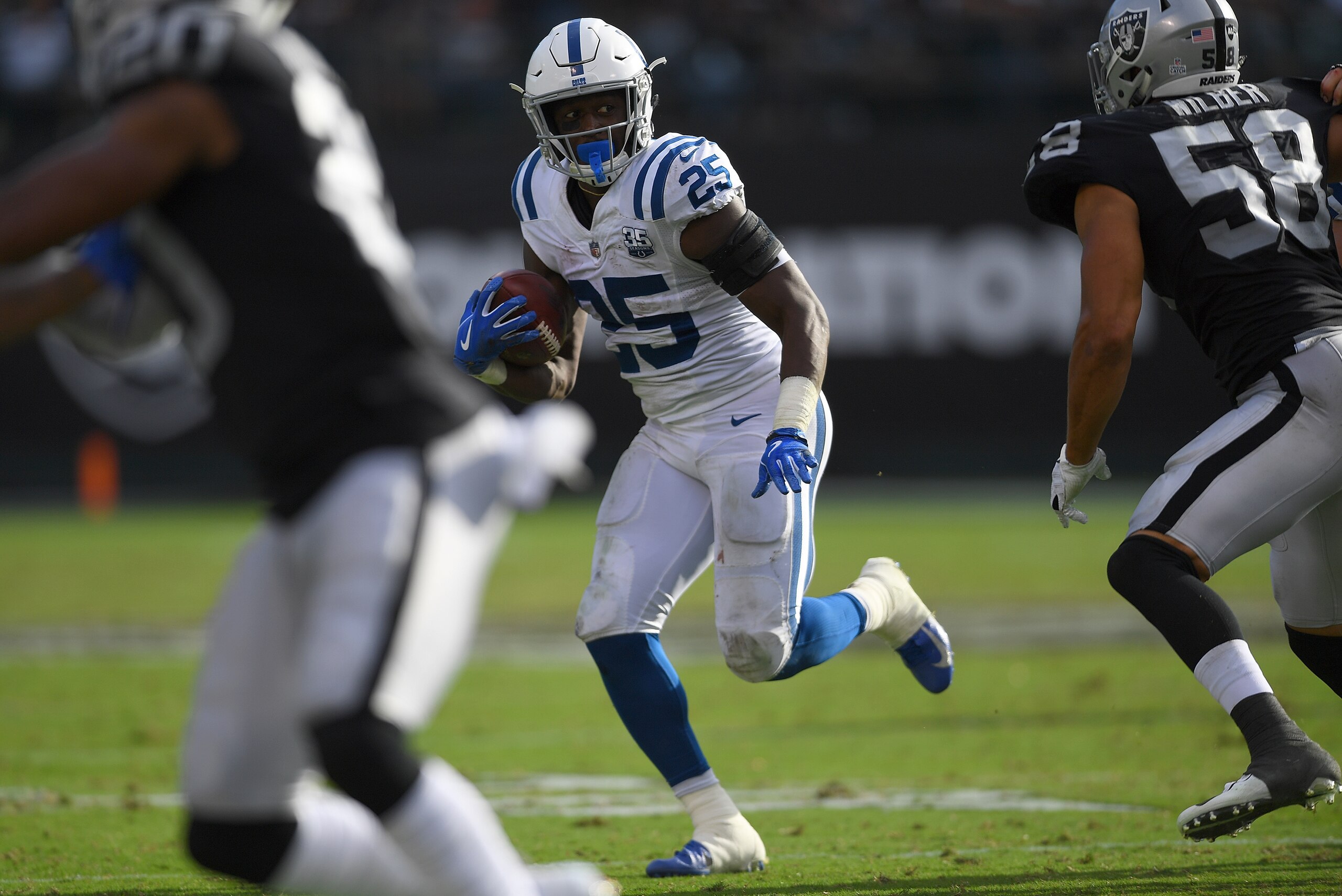 OAKLAND, CA - OCTOBER 28:  Marlon Mack #25 of the Indianapolis Colts carries the ball against the Oakland Raiders during the second half of their NFL football game at Oakland-Alameda County Coliseum on October 28, 2018 in Oakland, California.  (Photo by T