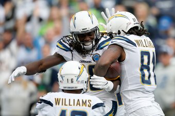 SEATTLE, WASHINGTON - NOVEMBER 04:  Melvin Gordon III #28, Tyrell Williams #16, and Mike Williams #81 of the Los Angeles Chargers celebrate after scoring a touchdown in the second quarter against the Seattle Seahawks at CenturyLink Field on November 04, 2