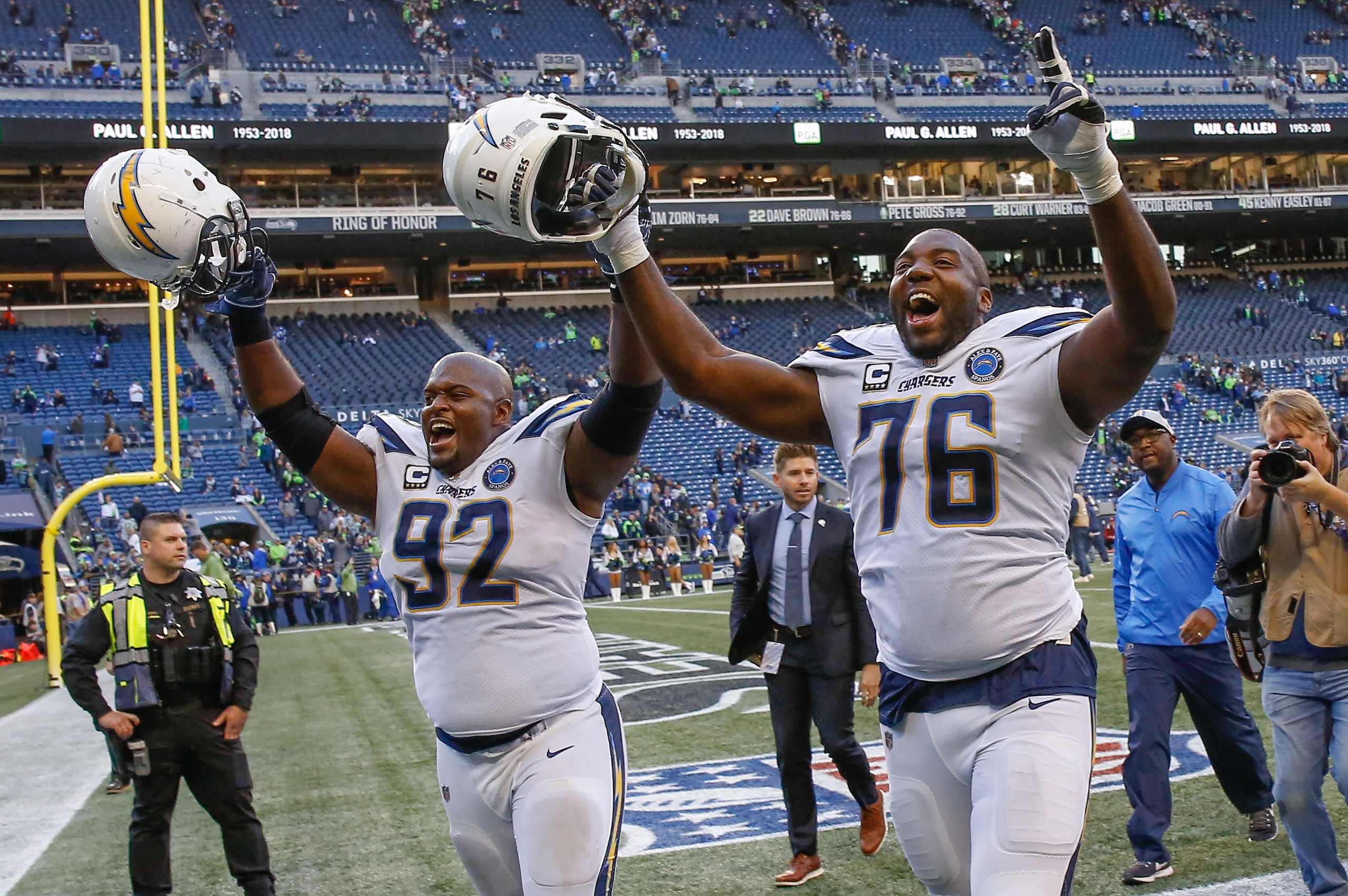 SEATTLE, WA - NOVEMBER 04:  Brandon Mebane #92 and Russell Okung #76 of the Los Angeles Chargers head off the field following the game against the Seattle Seahawks at CenturyLink Field on November 4, 2018 in Seattle, Washington.  (Photo by Otto Greule Jr/