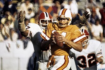 Tampa Bay Buccaneers quarterback Randy Hedberg (14) attampts to pass before being sacked by Atlanta Falcons defensive end Claude Humphrey in a 17-0 loss to the Atlanta Falcons on November 27, 1977 at Tampa Stadium in Tampa, Florida. (Photo by Sylvia Allen