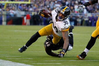 BALTIMORE, MD - NOVEMBER 04: Running Back James Conner #30 of the Pittsburgh Steelers is tackled by inside linebacker Patrick Onwuasor #48 of the Baltimore Ravens in the fourth quarter at M&T Bank Stadium on November 4, 2018 in Baltimore, Maryland. (Photo