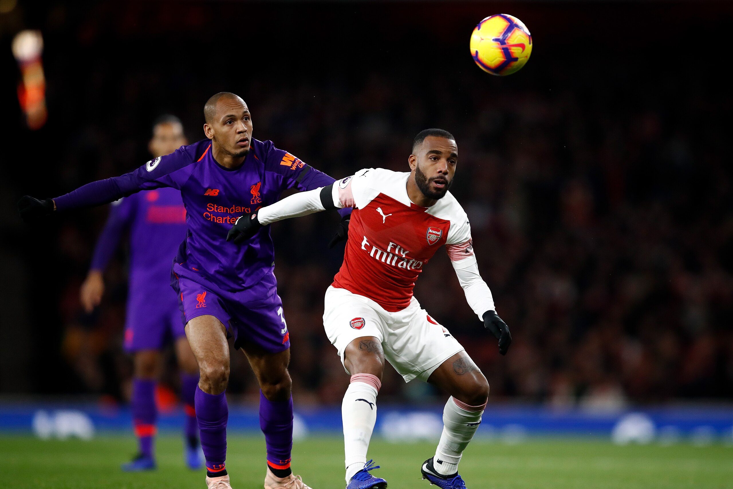 LONDON, ENGLAND - NOVEMBER 03: Alexandre Lacazette of Arsenal holds off Fabinho of Liverpool during the Premier League match between Arsenal FC and Liverpool FC at Emirates Stadium on November 3, 2018 in London, United Kingdom. (Photo by Julian Finney/G LONDON, ENGLAND - NOVEMBER 03: Alexandre Lacazette of Arsenal holds off Fabinho of Liverpool during the Premier League match between Arsenal FC and Liverpool FC at Emirates Stadium on November 3, 2018 in London, United Kingdom. (Photo by Julian Finney/G