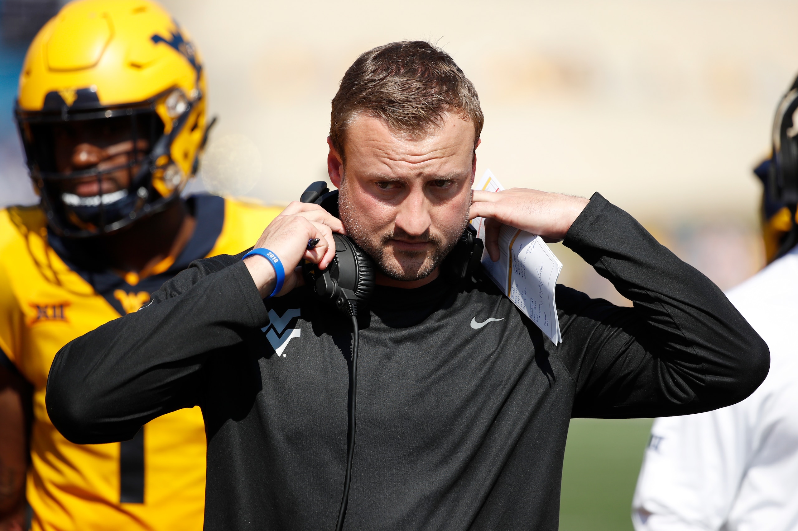 MORGANTOWN, WV - OCTOBER 06: Offensive coordinator Jake Spavital of the West Virginia Mountaineers looks on during the game against the Kansas Jayhawks at Mountaineer Field on October 6, 2018 in Morgantown, West Virginia. The Mountaineers won 38-22. (Phot