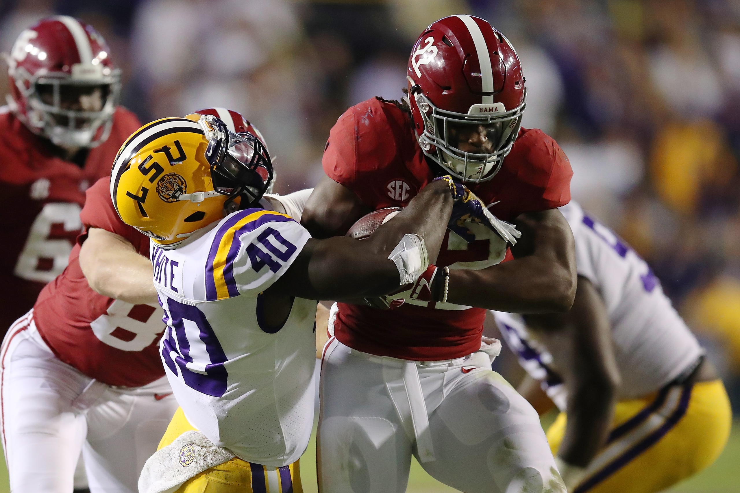 BATON ROUGE, LA - NOVEMBER 03: Najee Harris #22 of the Alabama Crimson Tide battles for yards while being tackled by Devin White #40 of the LSU Tigers during a second half run at Tiger Stadium on November 3, 2018 in Baton Rouge, Louisiana. Alabama won th BATON ROUGE, LA - NOVEMBER 03: Najee Harris #22 of the Alabama Crimson Tide battles for yards while being tackled by Devin White #40 of the LSU Tigers during a second half run at Tiger Stadium on November 3, 2018 in Baton Rouge, Louisiana. Alabama won th