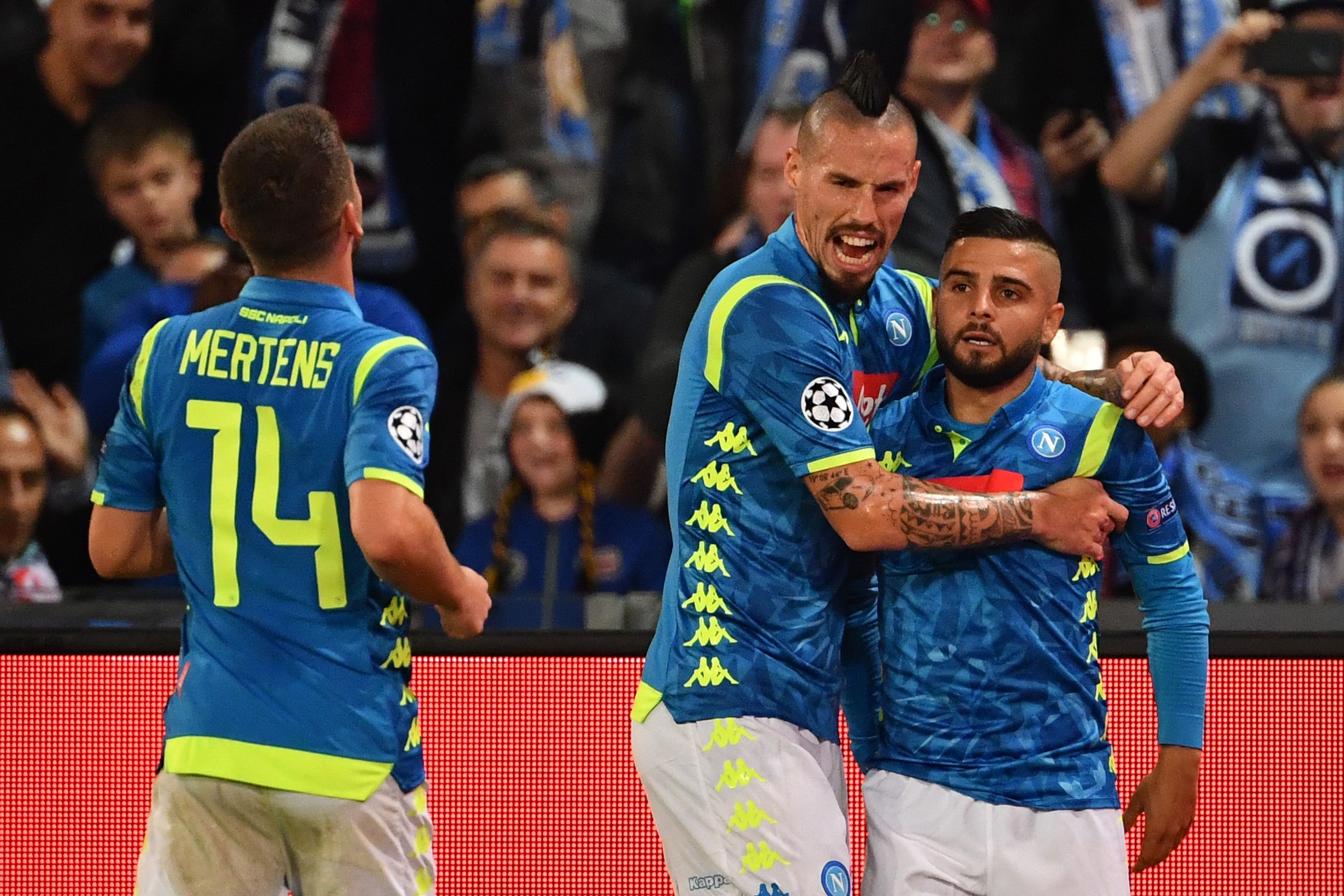 Napoli's Italian forward Lorenzo Insigne (R) is congratulated by Napoli's Slovak midfielder Marek Hamsik (C) after scoring a goal celebrates after scoring a goal during the European Champions League football match Napoli vs Paris Saint-Germain (PSG) on No