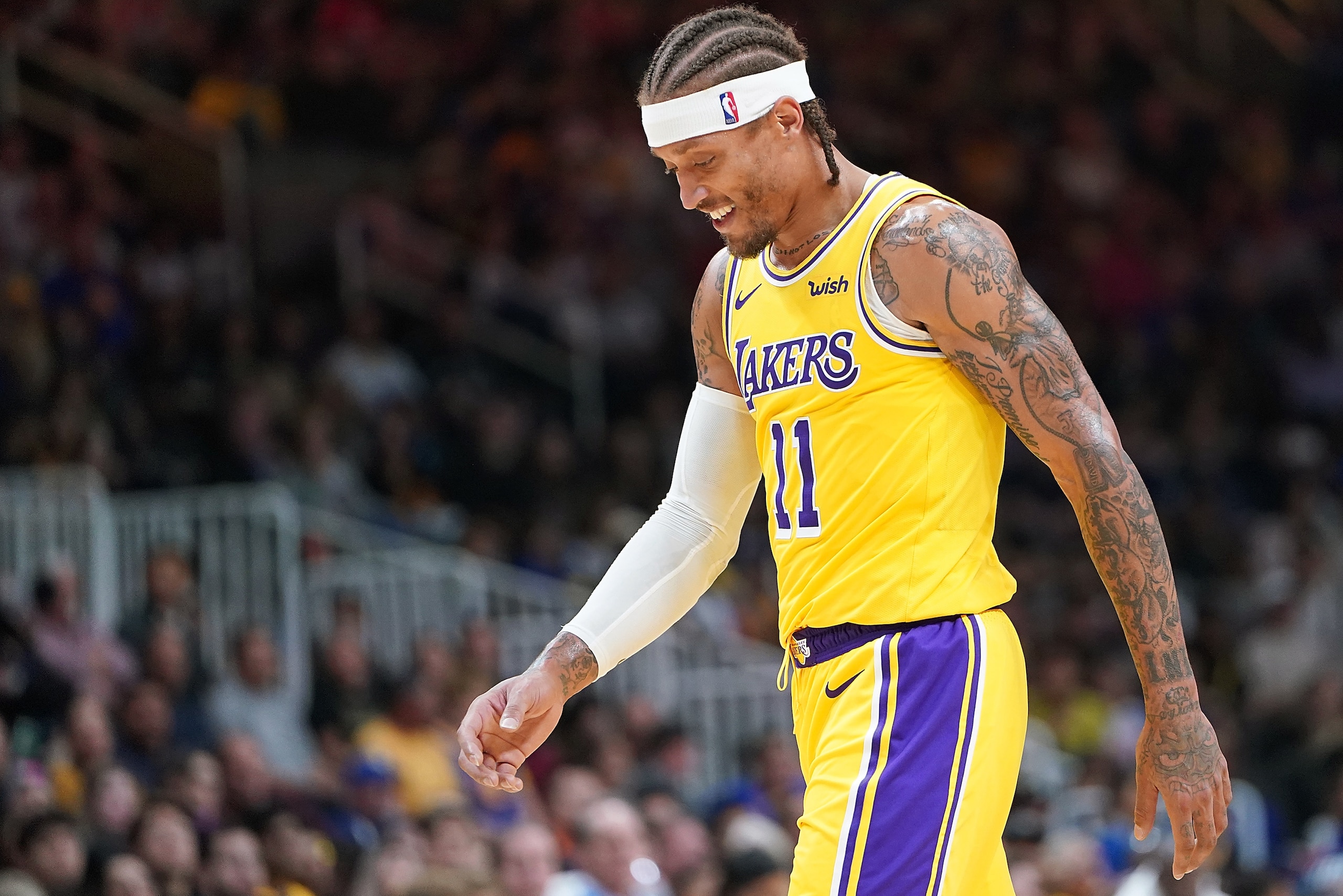 SAN JOSE, CA - OCTOBER 12:  Michael Beasley #11 of the Los Angeles Lakers walks off the court smiling after he received two technical fouls and was ejected from the game against the Golden State Warriors during the second half of their NBA basketball game