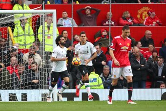 MANCHESTER, ENGLAND - MARCH 10: Roberto Firmino of Liverpool retrieves the ball after Eric Bailly of Manchester United scored an own goal to make it 2- 1  during the Premier League match between Manchester United and Liverpool at Old Trafford on March 10,