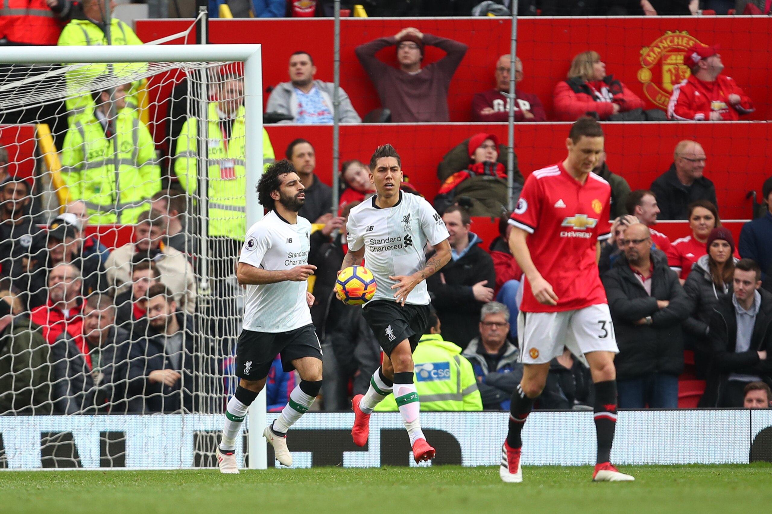 MANCHESTER, ENGLAND - MARCH 10: Roberto Firmino of Liverpool retrieves the ball after Eric Bailly of Manchester United scored an own goal to make it 2- 1 during the Premier League match between Manchester United and Liverpool at Old Trafford on March 10, MANCHESTER, ENGLAND - MARCH 10: Roberto Firmino of Liverpool retrieves the ball after Eric Bailly of Manchester United scored an own goal to make it 2- 1 during the Premier League match between Manchester United and Liverpool at Old Trafford on March 10,
