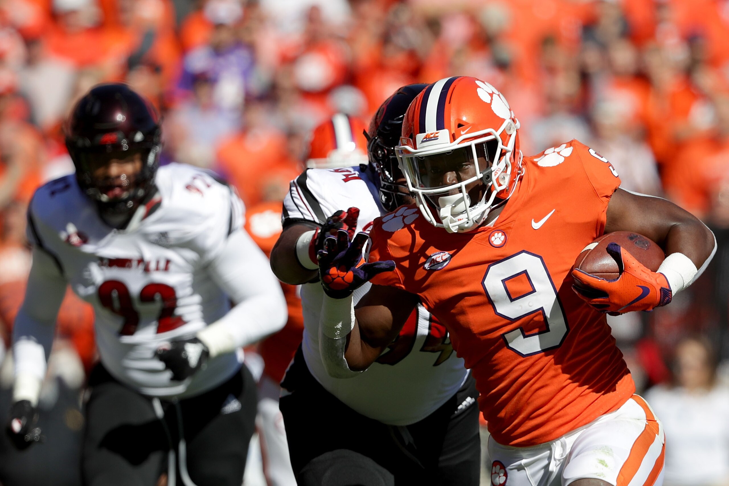 CLEMSON, SC - NOVEMBER 03:  G.G. Robinson #94 of the Louisville Cardinals tries to stop Travis Etienne #9 of the Clemson Tigers as he runs for a touchdown against the Louisville Cardinals during their game at Clemson Memorial Stadium on November 3, 2018 i