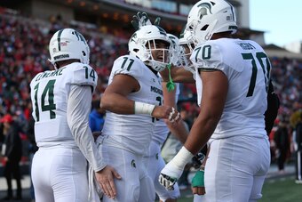 COLLEGE PARK, MD - NOVEMBER 03: Connor Heyward #11 of the Michigan State Spartans celebrates with Tyler Higby #70 and Brian Lewerke #14 of the Michigan State Spartans after scoring a touchdown against the Maryland Terrapins during the first half at Capita