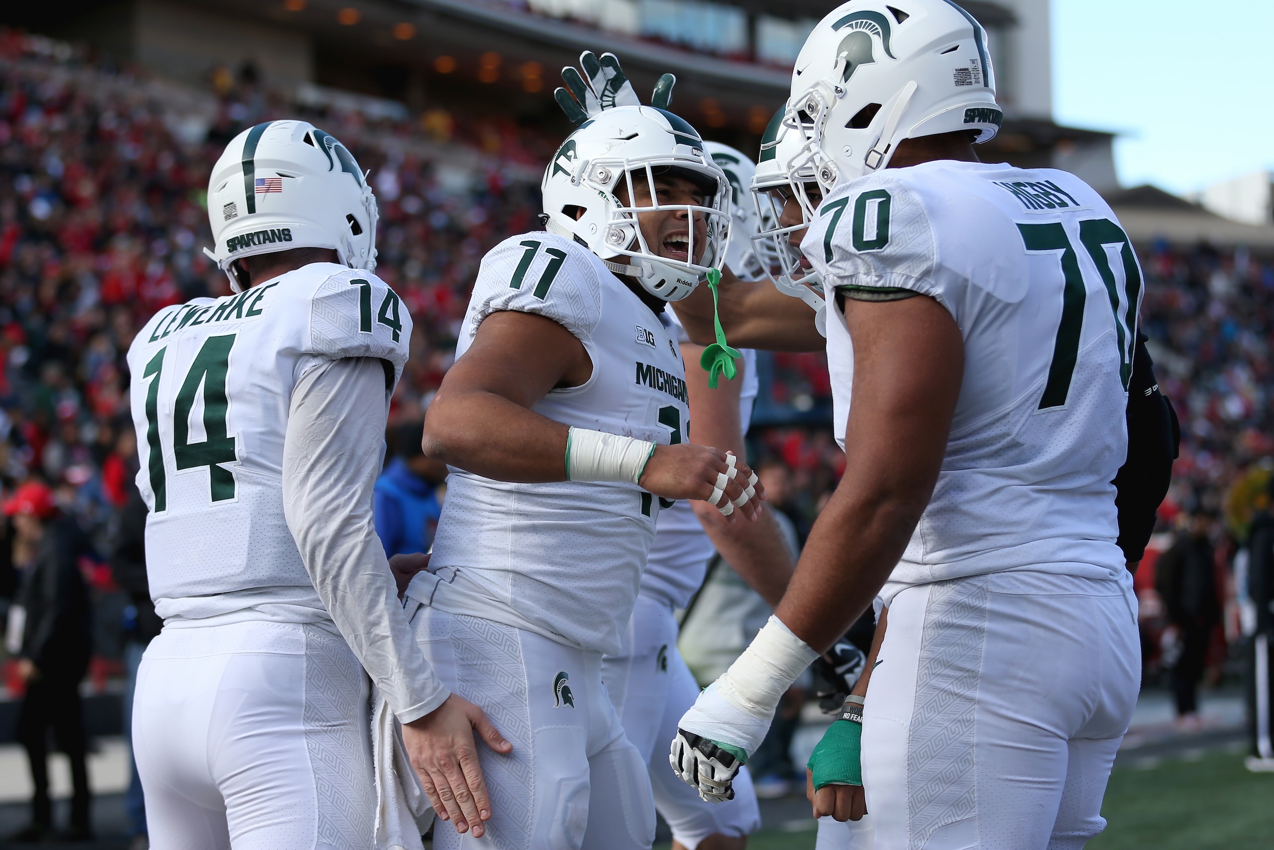 COLLEGE PARK, MD - NOVEMBER 03: Connor Heyward #11 of the Michigan State Spartans celebrates with Tyler Higby #70 and Brian Lewerke #14 of the Michigan State Spartans after scoring a touchdown against the Maryland Terrapins during the first half at Capita