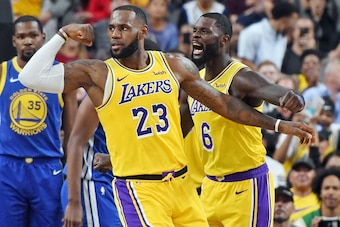 LAS VEGAS, NEVADA - OCTOBER 10:  LeBron James #23 and Lance Stephenson #6 of the Los Angeles Lakers celebrate after James made a shot against the Golden State Warriors and was fouled during their preseason game at T-Mobile Arena on October 10, 2018 in Las