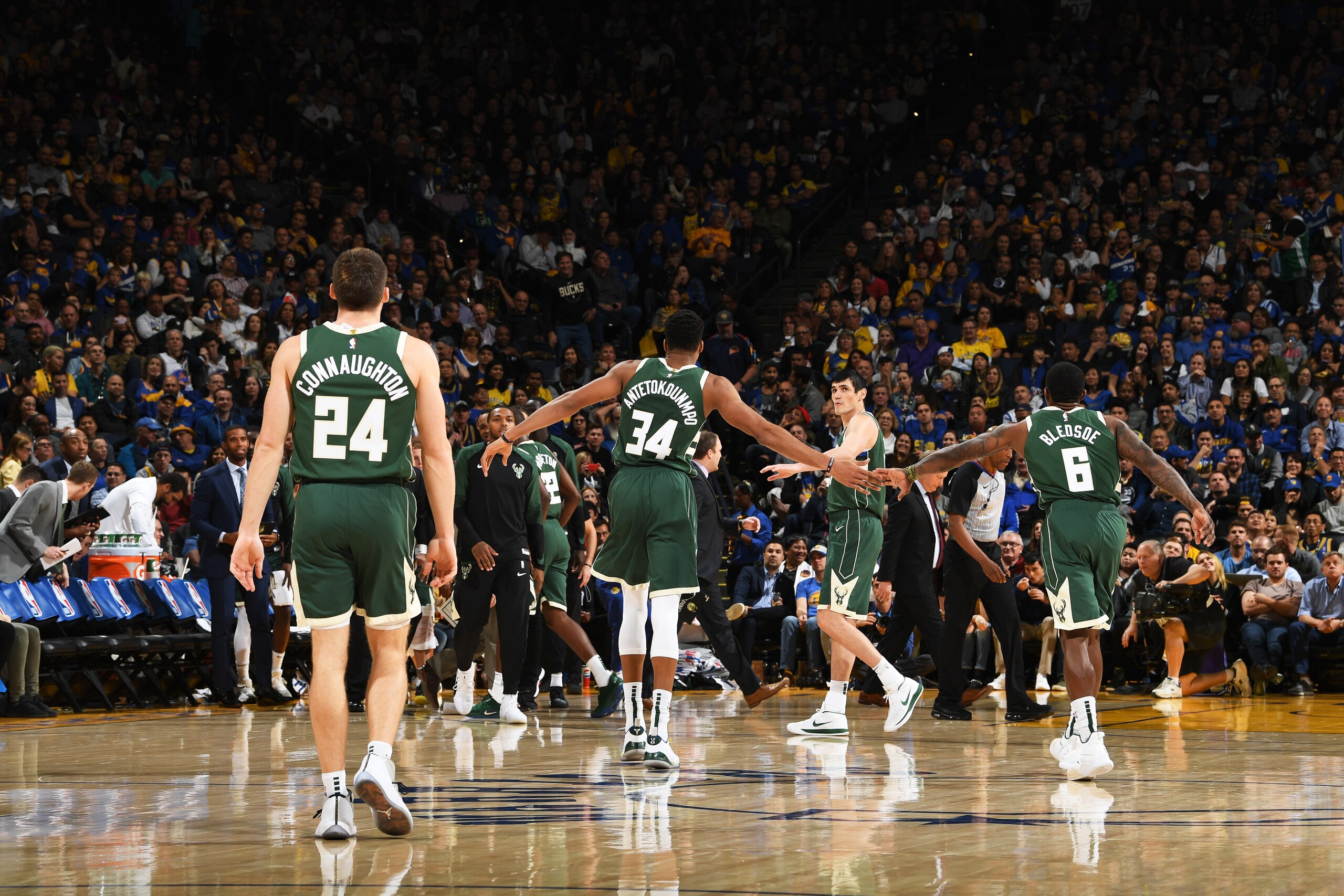 OAKLAND, CA - NOVEMBER 8: Giannis Antetokounmpo #34 of the Milwaukee Bucks high-fives teammates during the game against the Golden State Warriors on November 8, 2018 at ORACLE Arena in Oakland, California. NOTE TO USER: User expressly acknowledges and agr