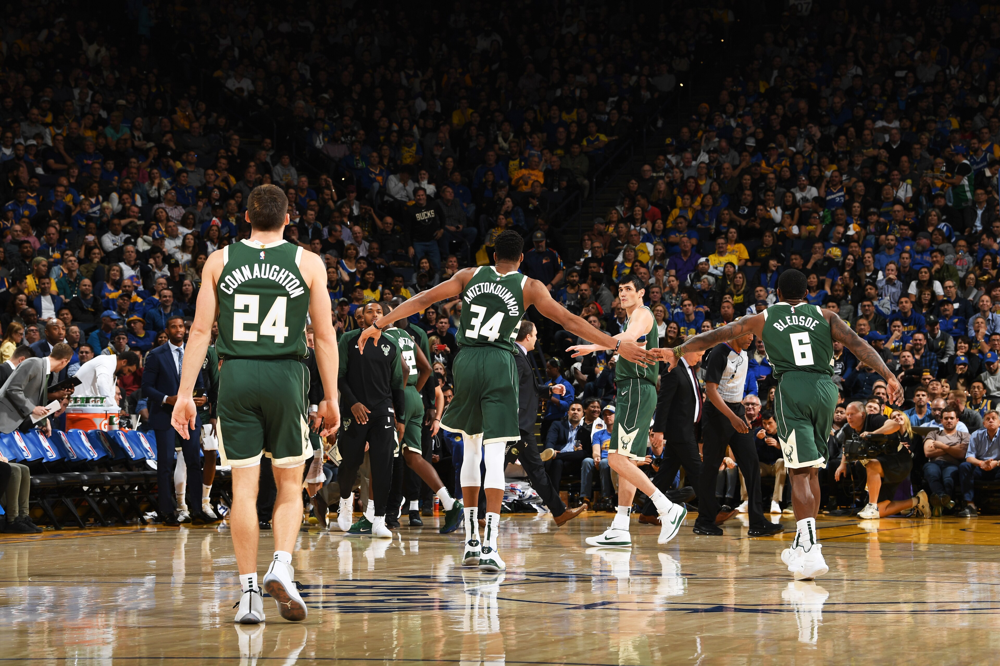 OAKLAND, CA - NOVEMBER 8: Giannis Antetokounmpo #34 of the Milwaukee Bucks high-fives teammates during the game against the Golden State Warriors on November 8, 2018 at ORACLE Arena in Oakland, California. NOTE TO USER: User expressly acknowledges and agr