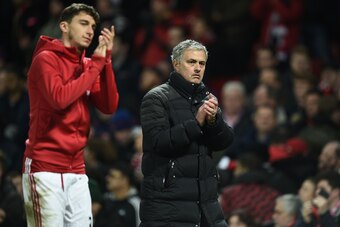 Manchester United's Portuguese manager Jose Mourinho (R) and Manchester United's Italian defender Matteo Darmian (L) applaud supporters on the pitch after the English Premier League football match between Manchester United and Liverpool at Old Trafford in