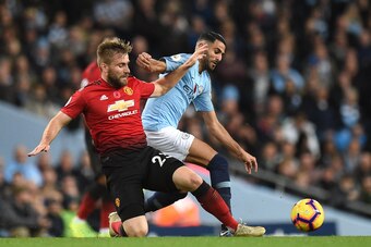 Manchester United's English defender Luke Shaw (L) vies with Manchester City's Algerian midfielder Riyad Mahrez during the English Premier League football match between Manchester City and Manchester United at the Etihad Stadium in Manchester, north west 