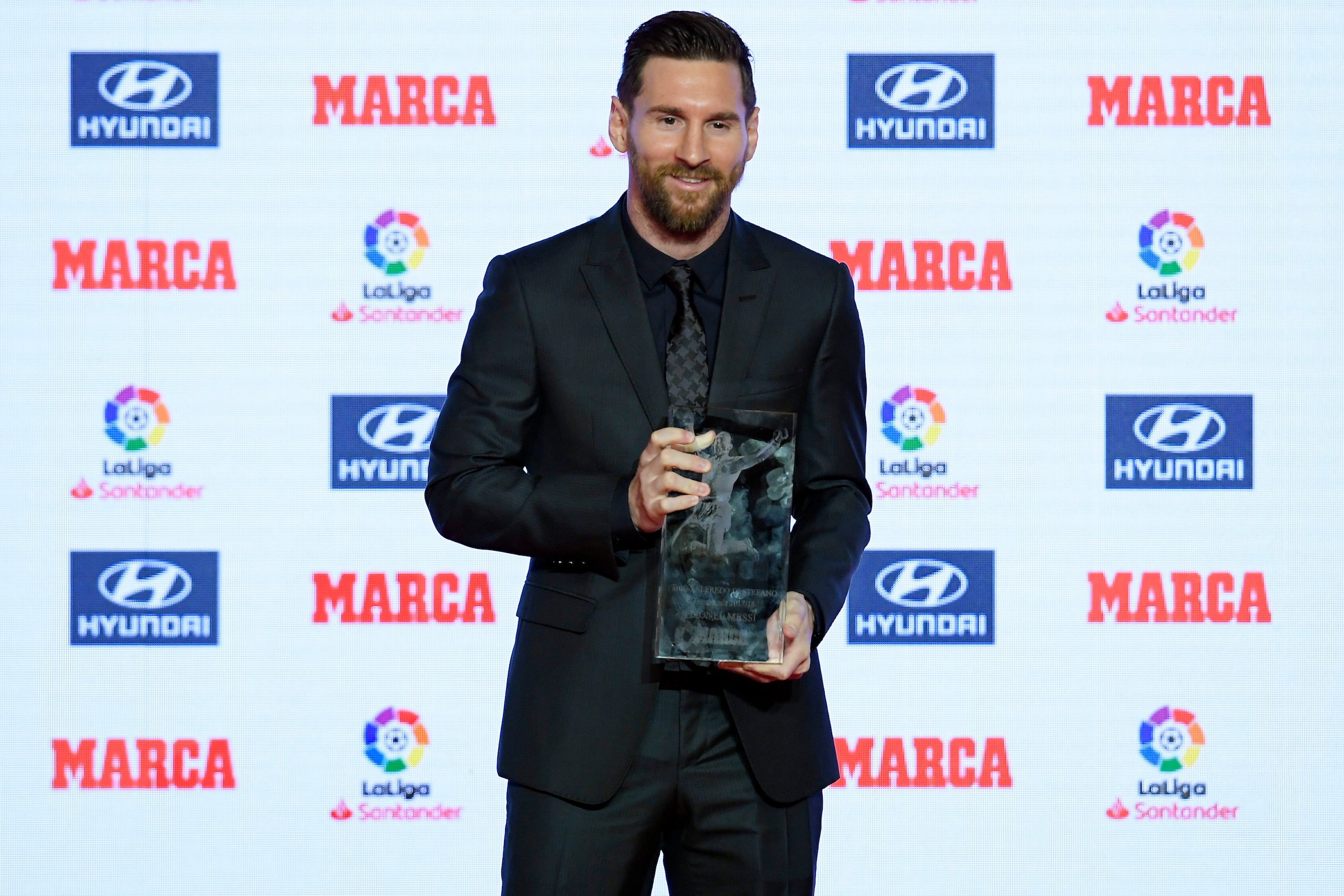 Barcelona's Argentinian forward Lionel Messi receives the Alfredo Di Stefano trophy for the 2017-18 best player of the Spanish Liga, during the presentation of the Football Marca Awards in Barcelona on November 12, 2018. (Photo by LLUIS GENE / AFP)       