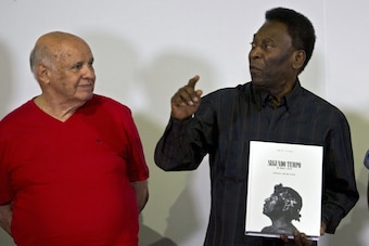 Brazilian football legend Edson Arantes do Nascimento, known as 'Pele' (C), speaks next to former teammates Pepe (L) and Coutinho (R), during the autograph ceremony of his book 'Segundo Tempo' (Second Half), in Santos, some 70 km from Sao Paulo, Brazil, o