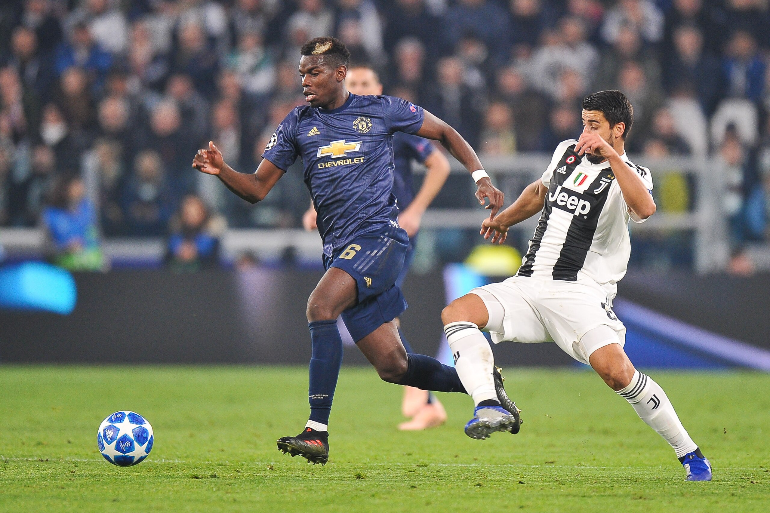 TURIN, ITALY - NOVEMBER 07: Paul Pogba of Manchester United competes with Sami Khedira of Juventus FC during the Group H match of the UEFA Champions League between Juventus and Manchester United at Juventus Stadium on November 7, 2018 in Turin, Italy. (Ph