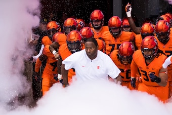 SYRACUSE, NY - OCTOBER 20:  Syracuse Orange players and head coach Dino Babers run onto the field before the game against the North Carolina Tar Heels at the Carrier Dome on October 20, 2018 in Syracuse, New York. Syracuse defeats North Carolina in overti