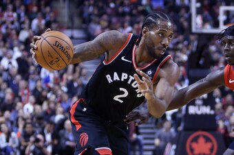 TORONTO, ON - NOVEMBER 12:  Kawhi Leonard #2 of the Toronto Raptors dribbles the ball as Jrue Holiday #11 of the New Orleans Pelicans defends during the second half of an NBA game at Scotiabank Arena on November 12, 2018 in Toronto, Canada.  NOTE TO USER:
