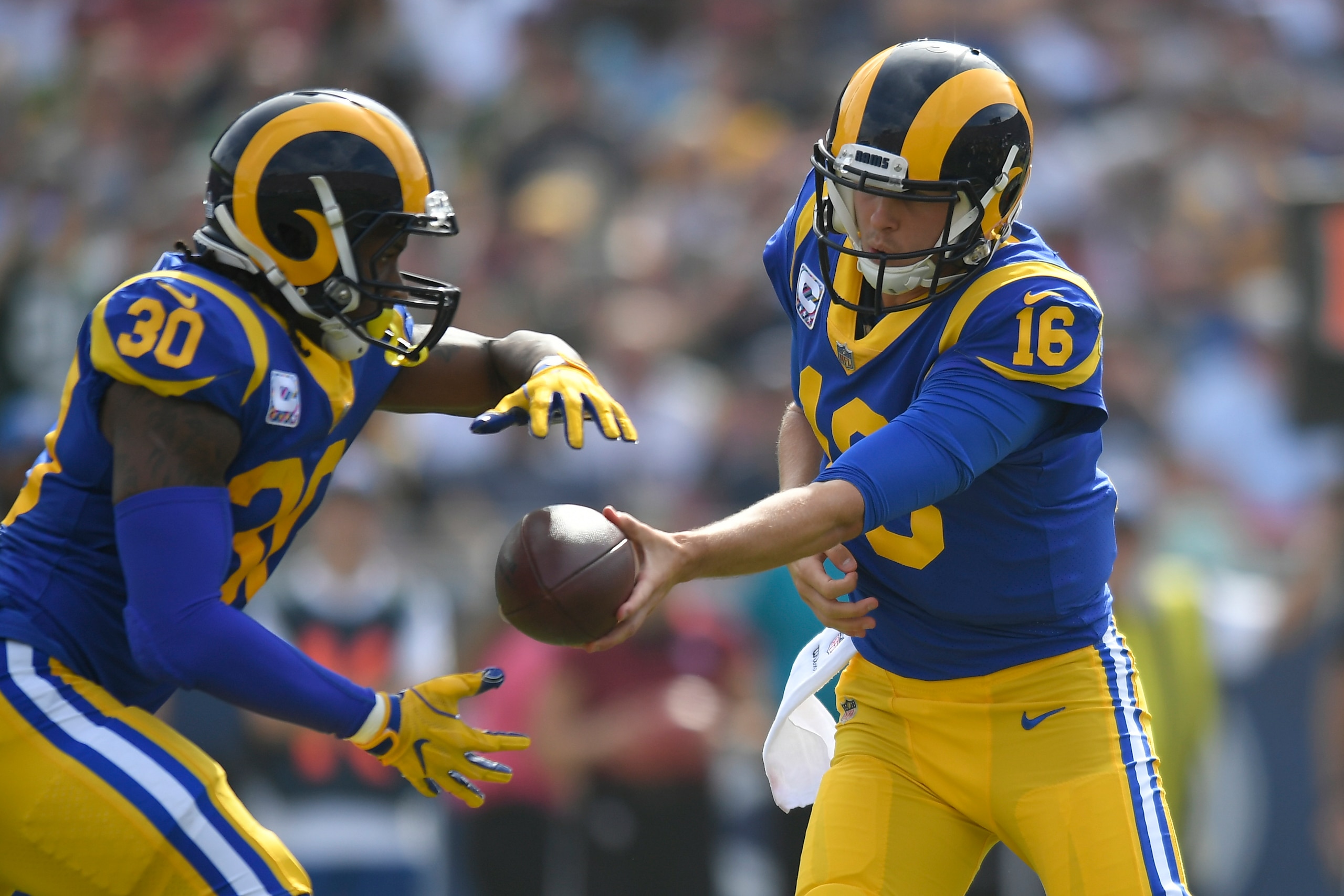 LOS ANGELES, CA - OCTOBER 28: Todd Gurley #30 takes a handoff from Jared Goff #16 of the Los Angeles Rams at Los Angeles Memorial Coliseum on October 28, 2018 in Los Angeles, California. (Photo by John McCoy/Getty Images)