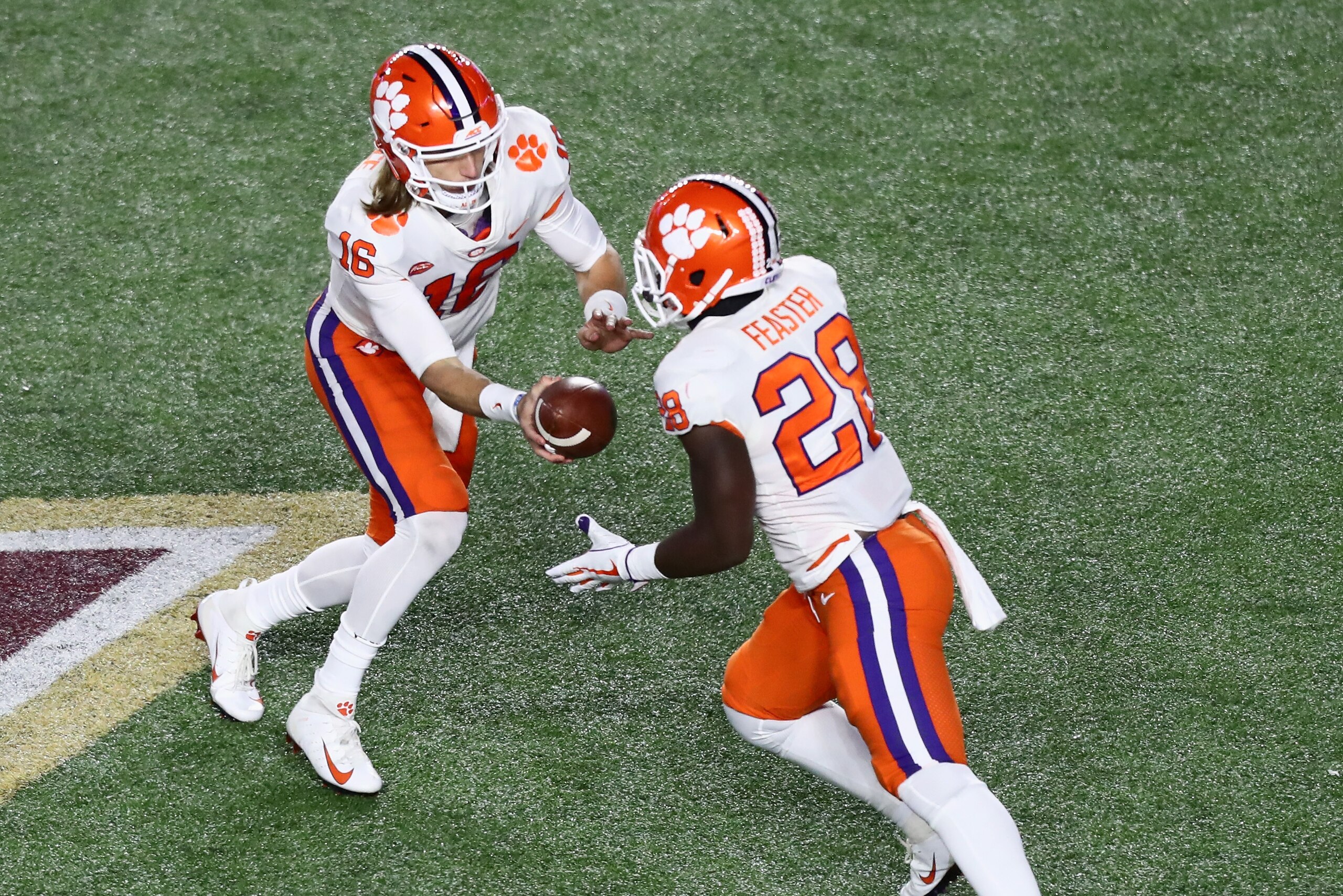 CHESTNUT HILL, MA - NOVEMBER 10:  Quarterback Trevor Lawrence #16 of the Clemson Tigers hands off to Tavien Feaster #28 of the Clemson Tigers during the third quarter of the game against the Boston College Eagles at Alumni Stadium on November 10, 2018 in 