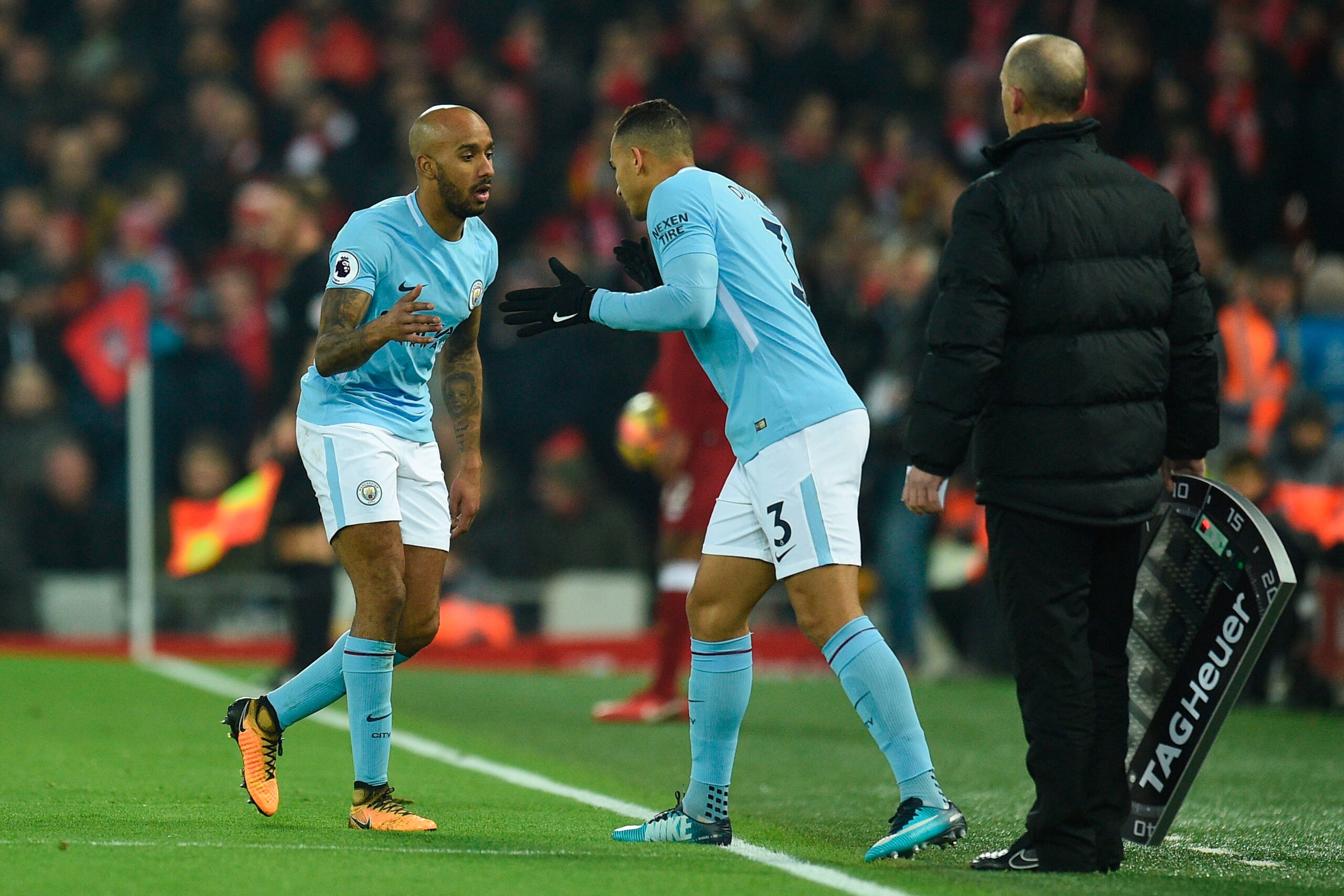 Manchester City's English midfielder Fabian Delph (L) goes off injured to be replaced by Manchester City's Brazilian defender Danilo (C) during the English Premier League football match between Liverpool and Manchester City at Anfield in Liverpool, north 