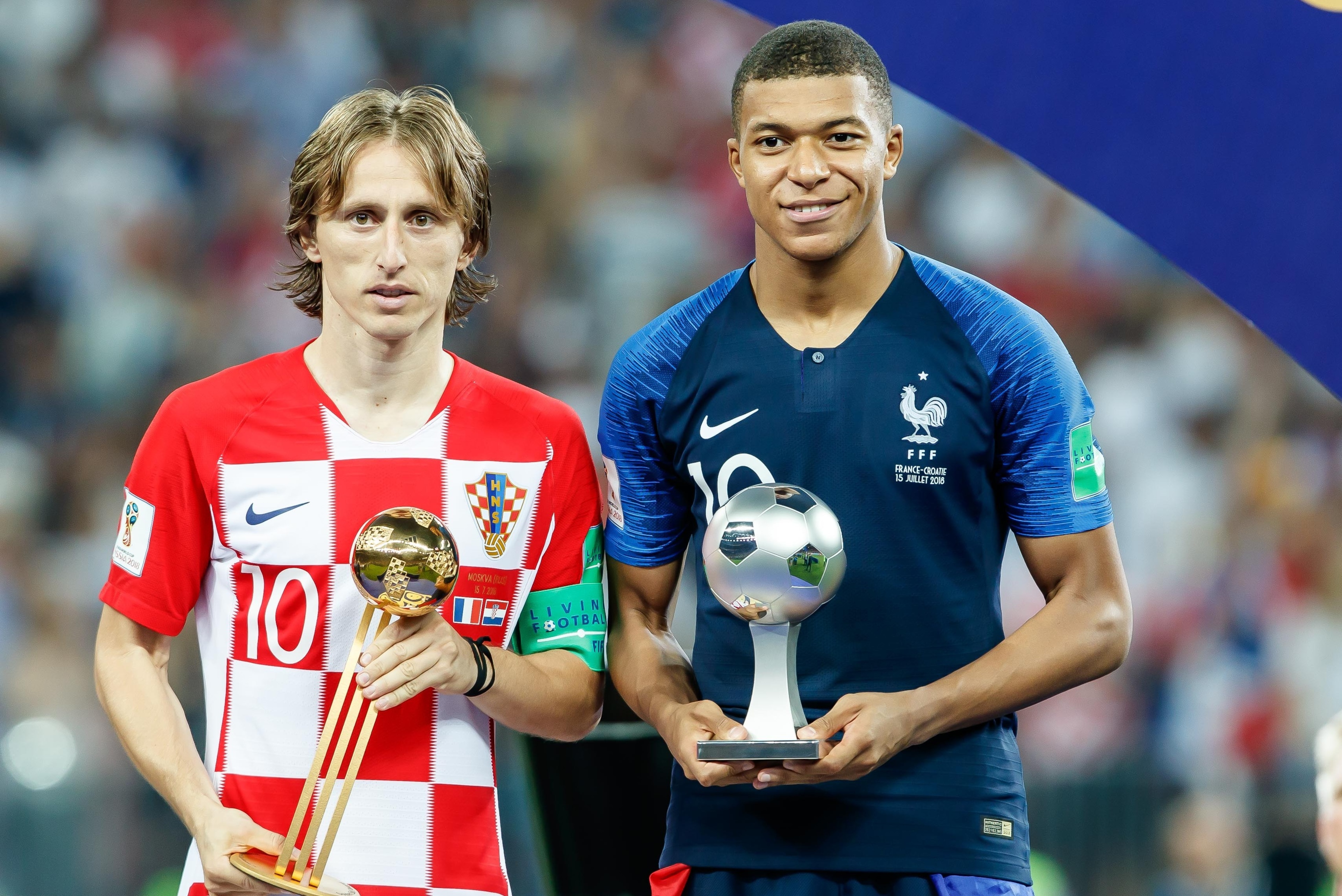 MOSCOW, RUSSIA - JULY 15: Luka Modric of Croatia and Kylian Mbappe of France pose with the Golden Ball Award trophy and the Young Player Award trophy, during the 2018 FIFA World Cup Russia Final between France and Croatia at Luzhniki Stadium on July 15, 2
