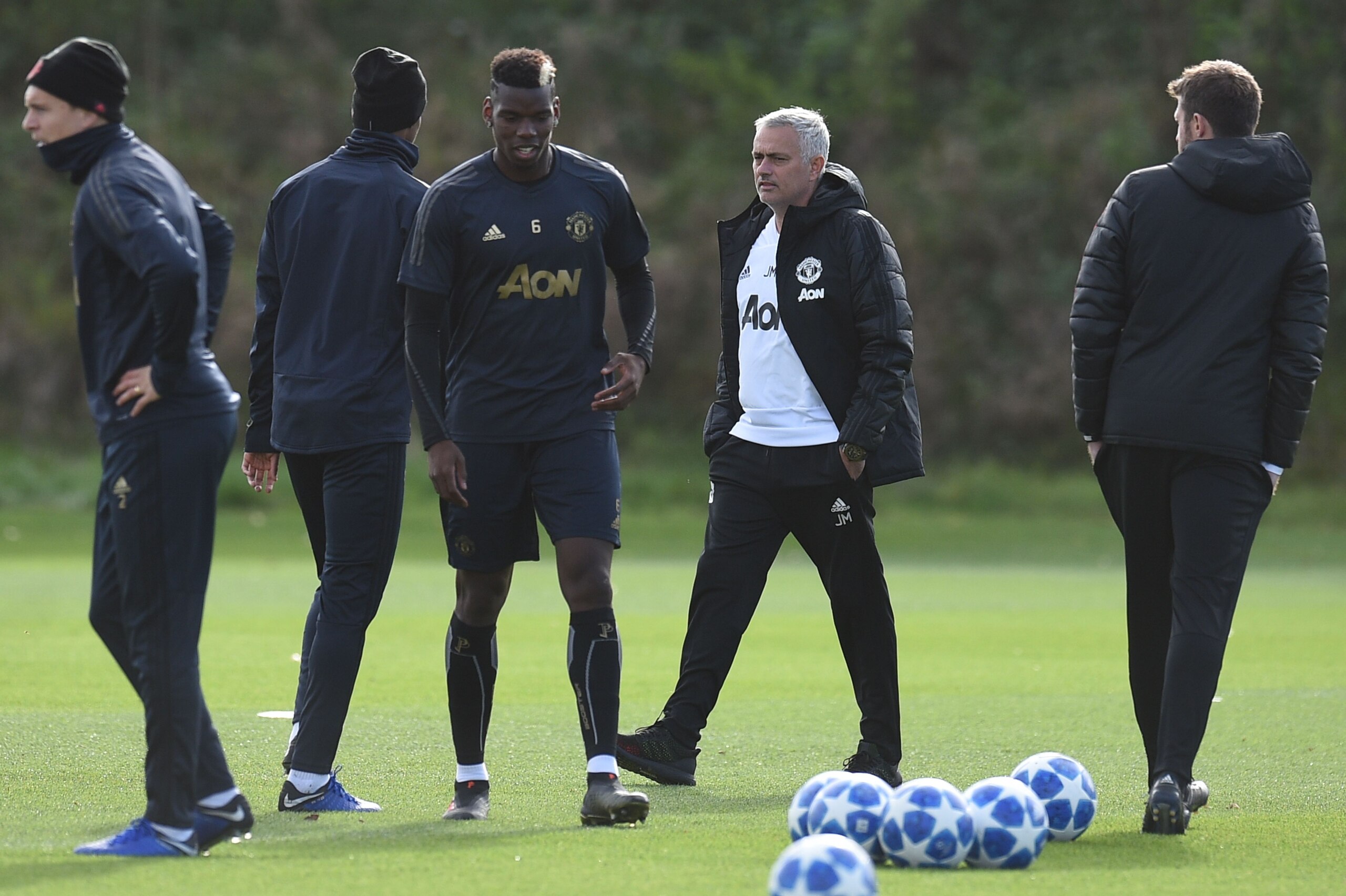 Manchester United's Portuguese manager Jose Mourinho watches his players, including Manchester United's French midfielder Paul Pogba (3L), as he attends a training session at the Carrington Training complex in Manchester, north west England on October 22,