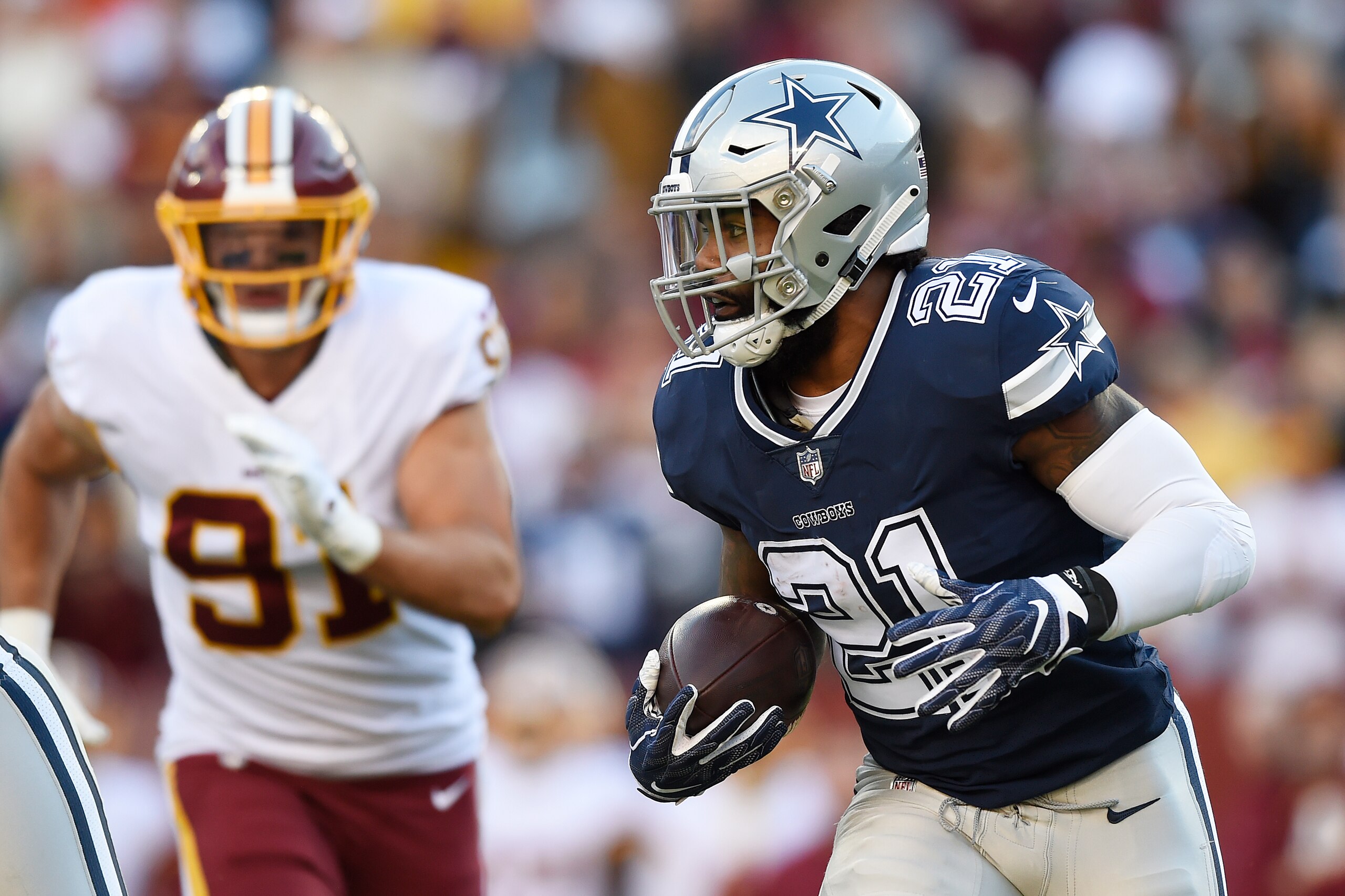 LANDOVER, MD - OCTOBER 21: Running back Ezekiel Elliott #21 of the Dallas Cowboys runs with the ball in the first quarter against the Washington Redskins at FedExField on October 21, 2018 in Landover, Maryland. (Photo by Patrick McDermott/Getty Images) LANDOVER, MD - OCTOBER 21: Running back Ezekiel Elliott #21 of the Dallas Cowboys runs with the ball in the first quarter against the Washington Redskins at FedExField on October 21, 2018 in Landover, Maryland. (Photo by Patrick McDermott/Getty Images)