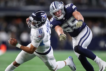 ARLINGTON, TX - NOVEMBER 05:  Marcus Mariota #8 of the Tennessee Titans is pursued byLeighton Vander Esch #55 of the Dallas Cowboys in the fourth quarter of a football game at AT&T Stadium on November 5, 2018 in Arlington, Texas.  (Photo by Tom Pennington